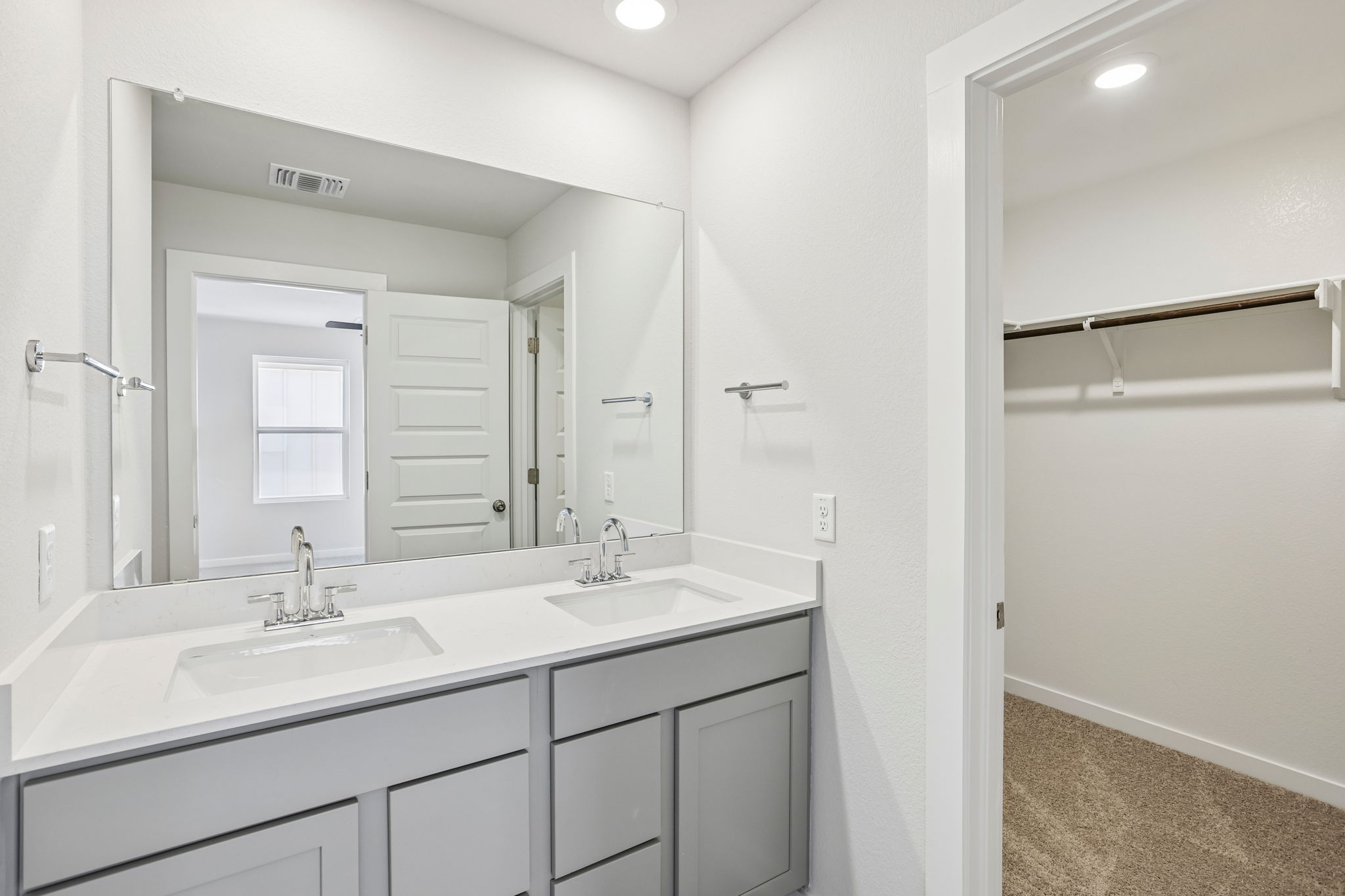 A bathroom with a large mirror.