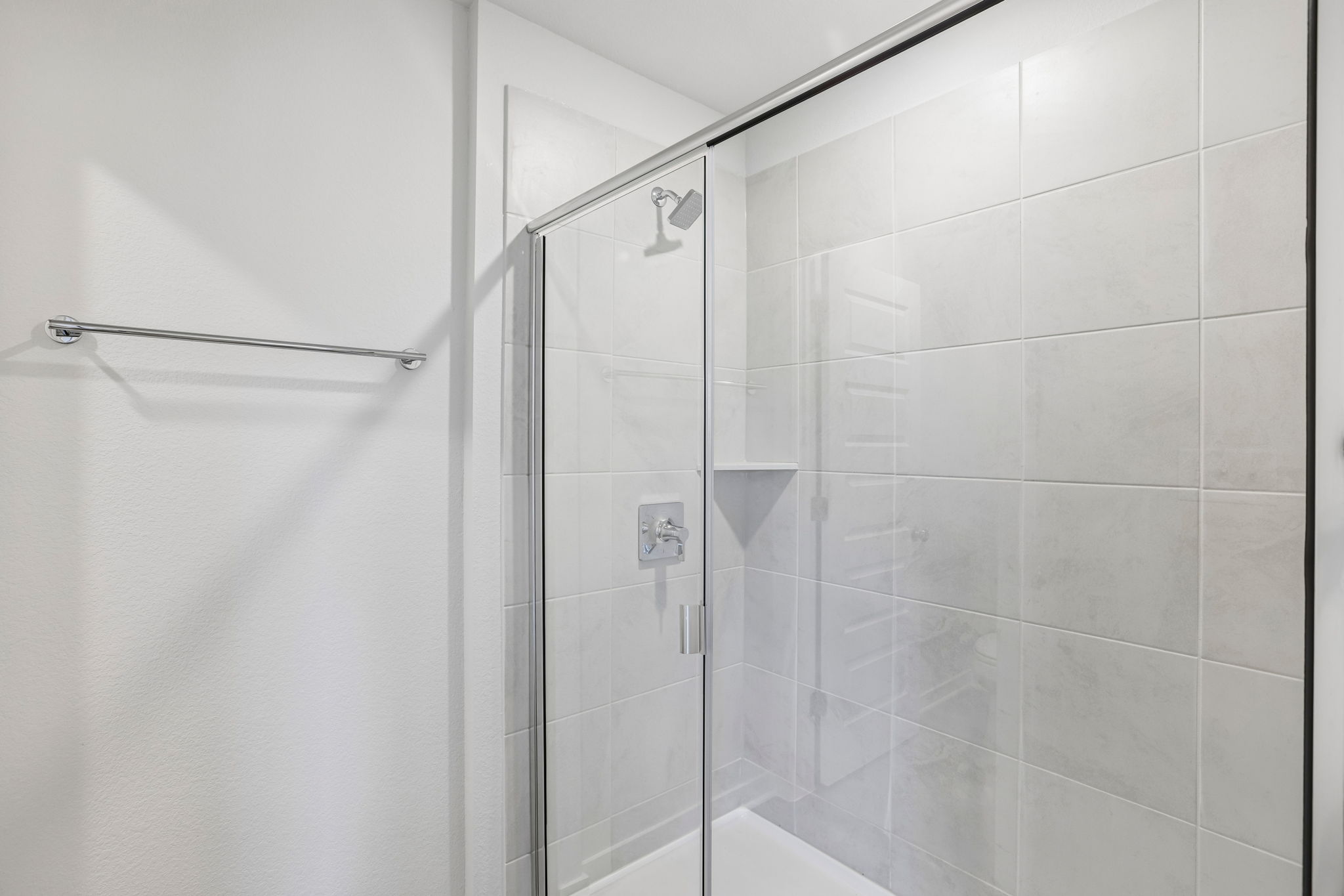 A shower with a glass door.