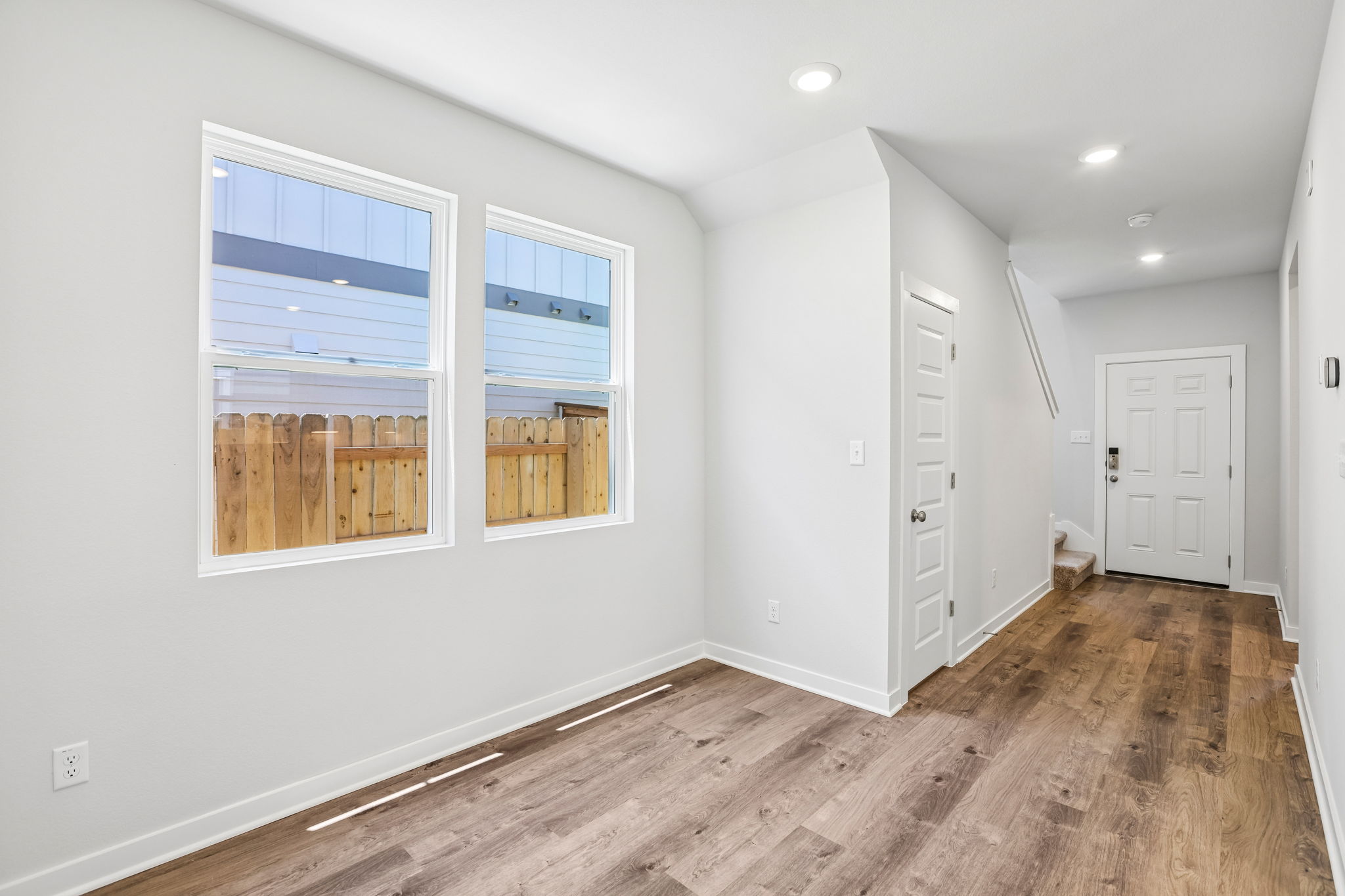 A room with a wood floor and a window.