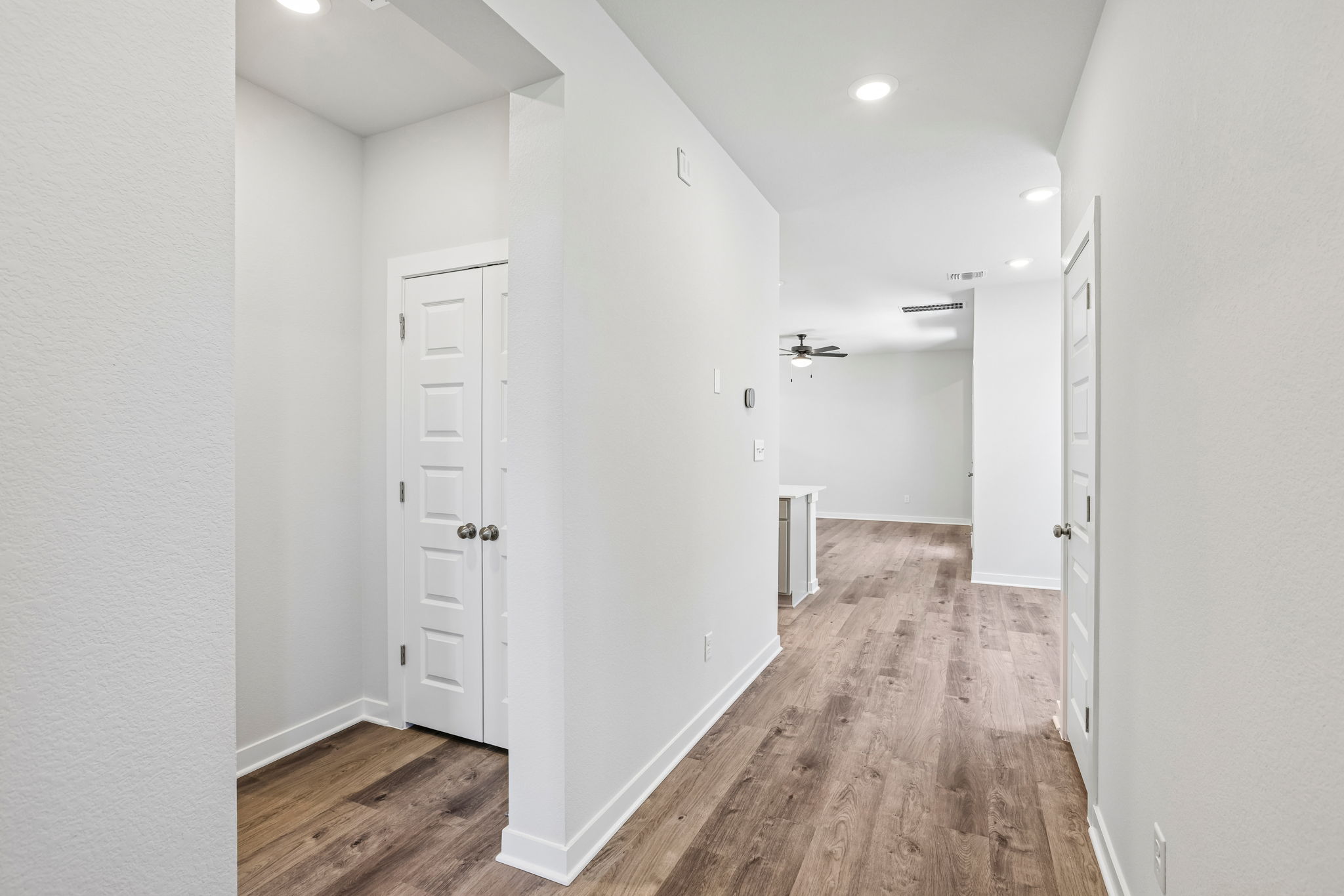 A hallway with white doors.