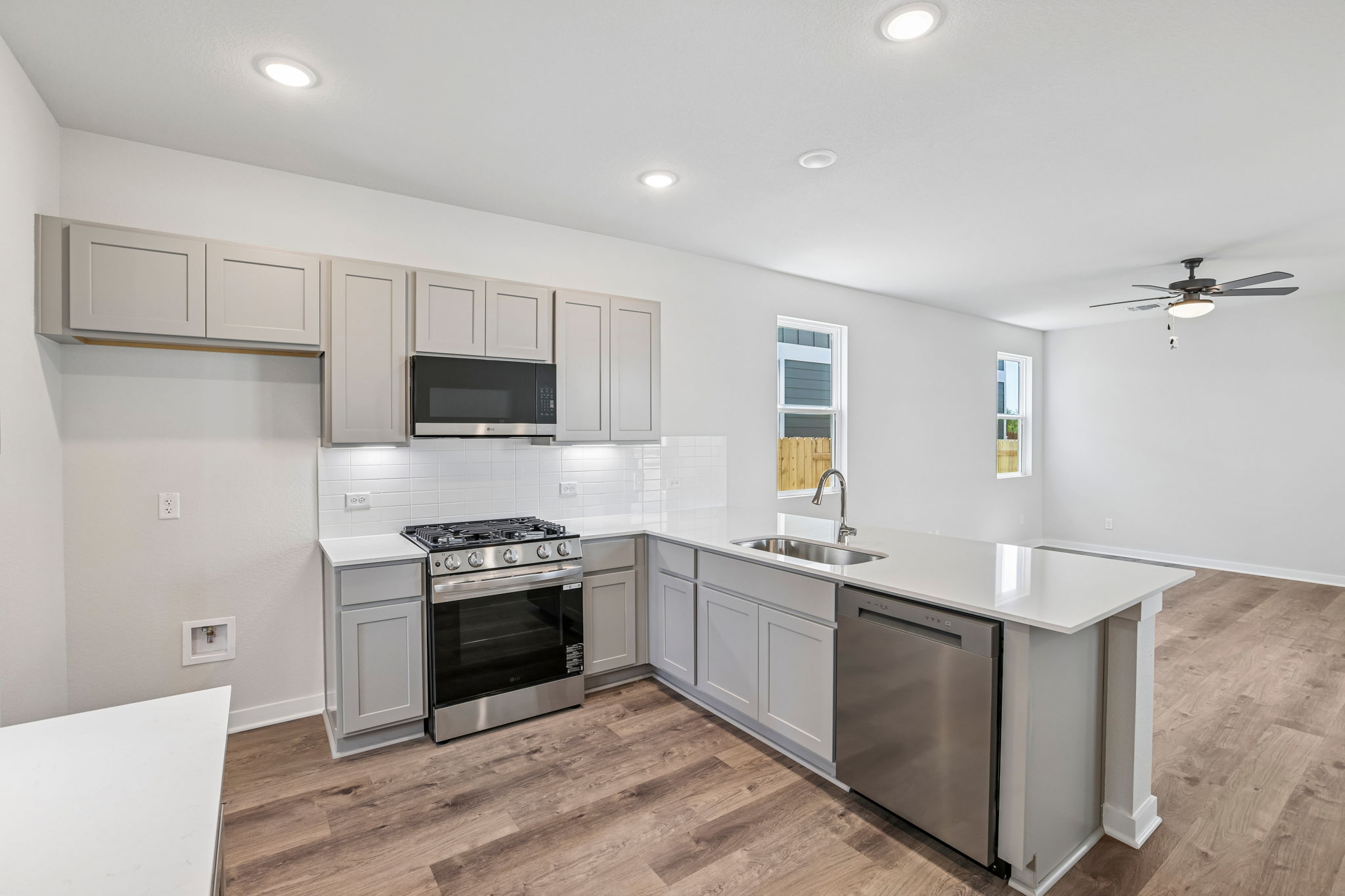 A kitchen with white cabinets.