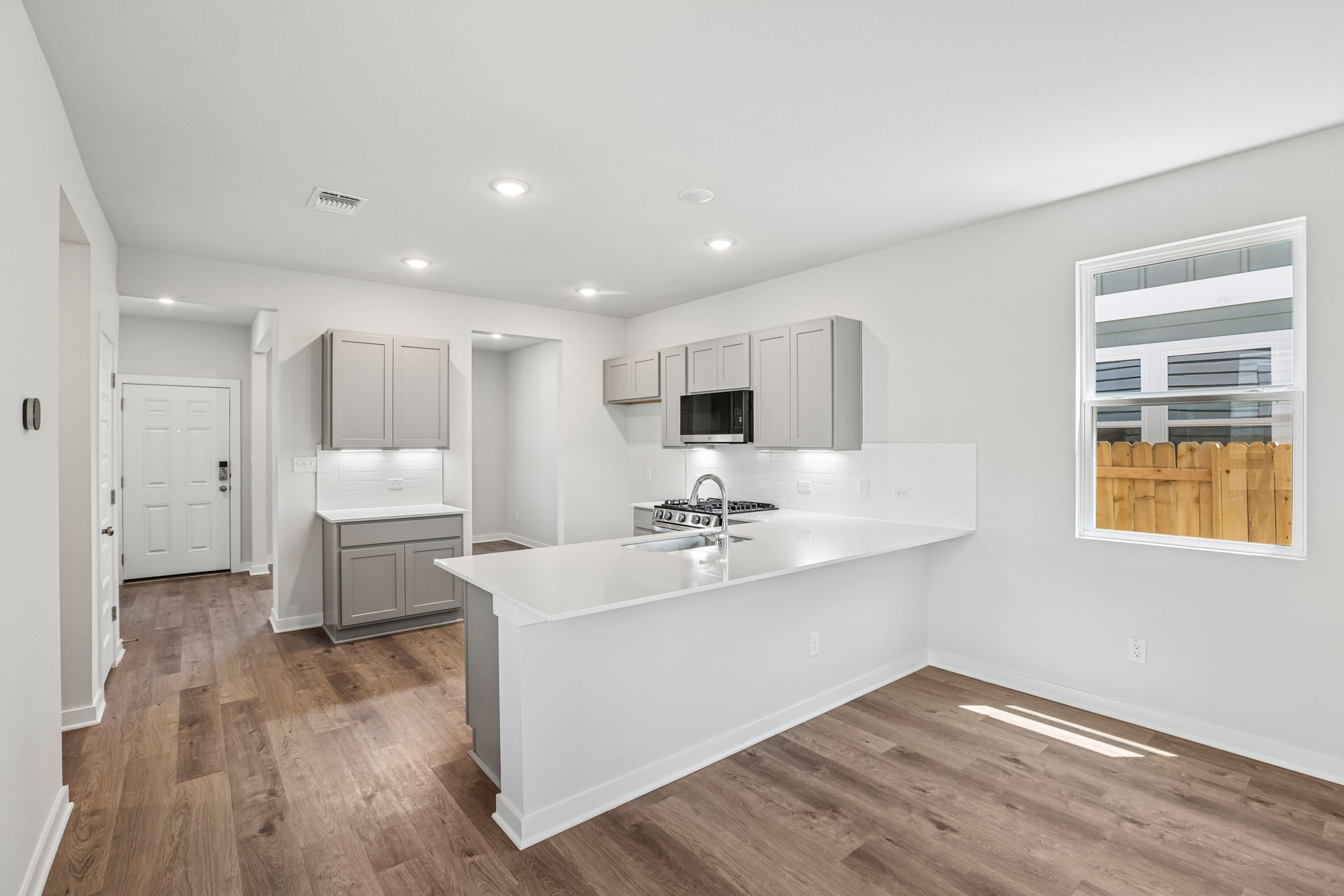 A kitchen with white cabinets.
