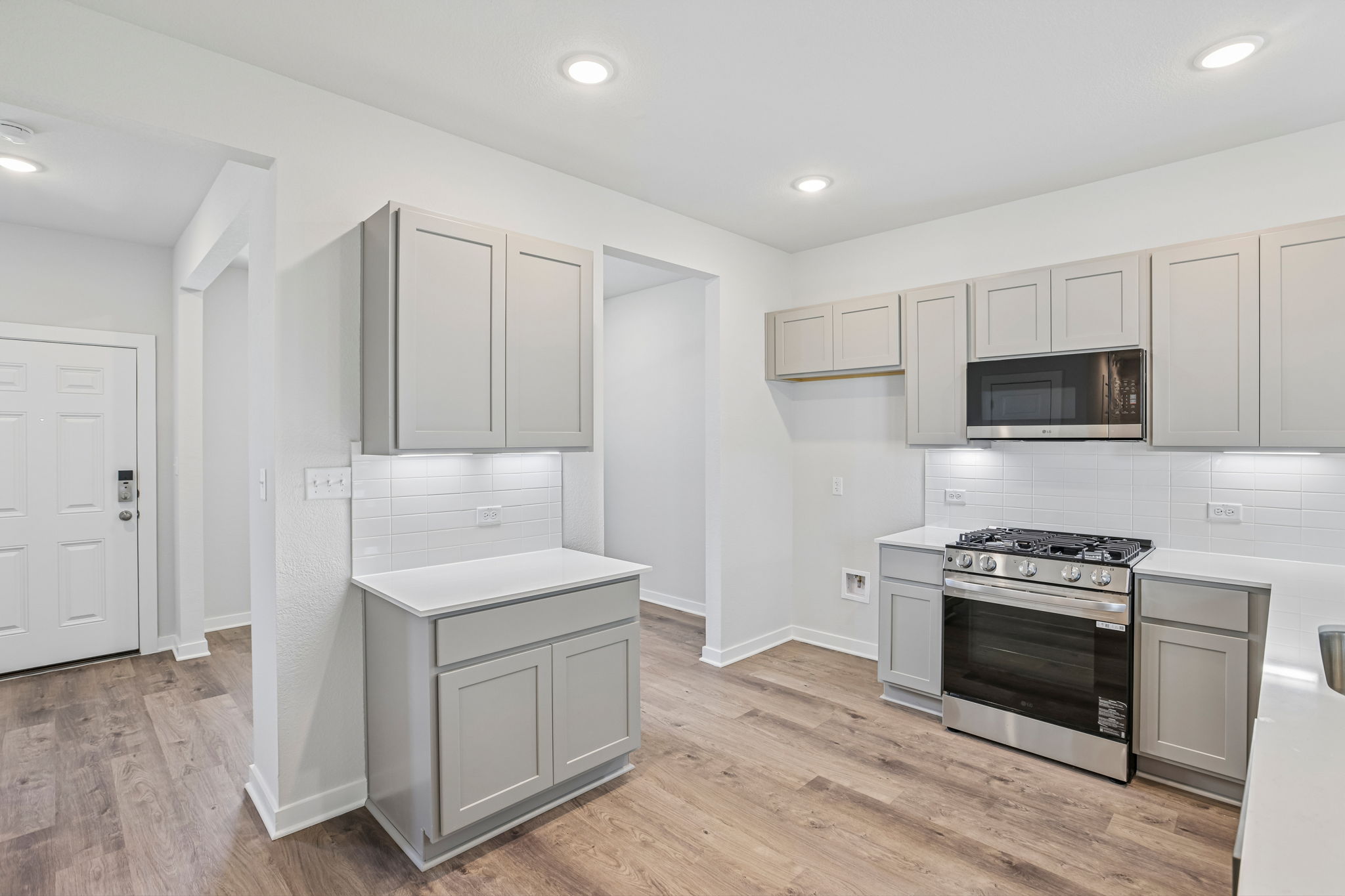 A kitchen with white cabinets.