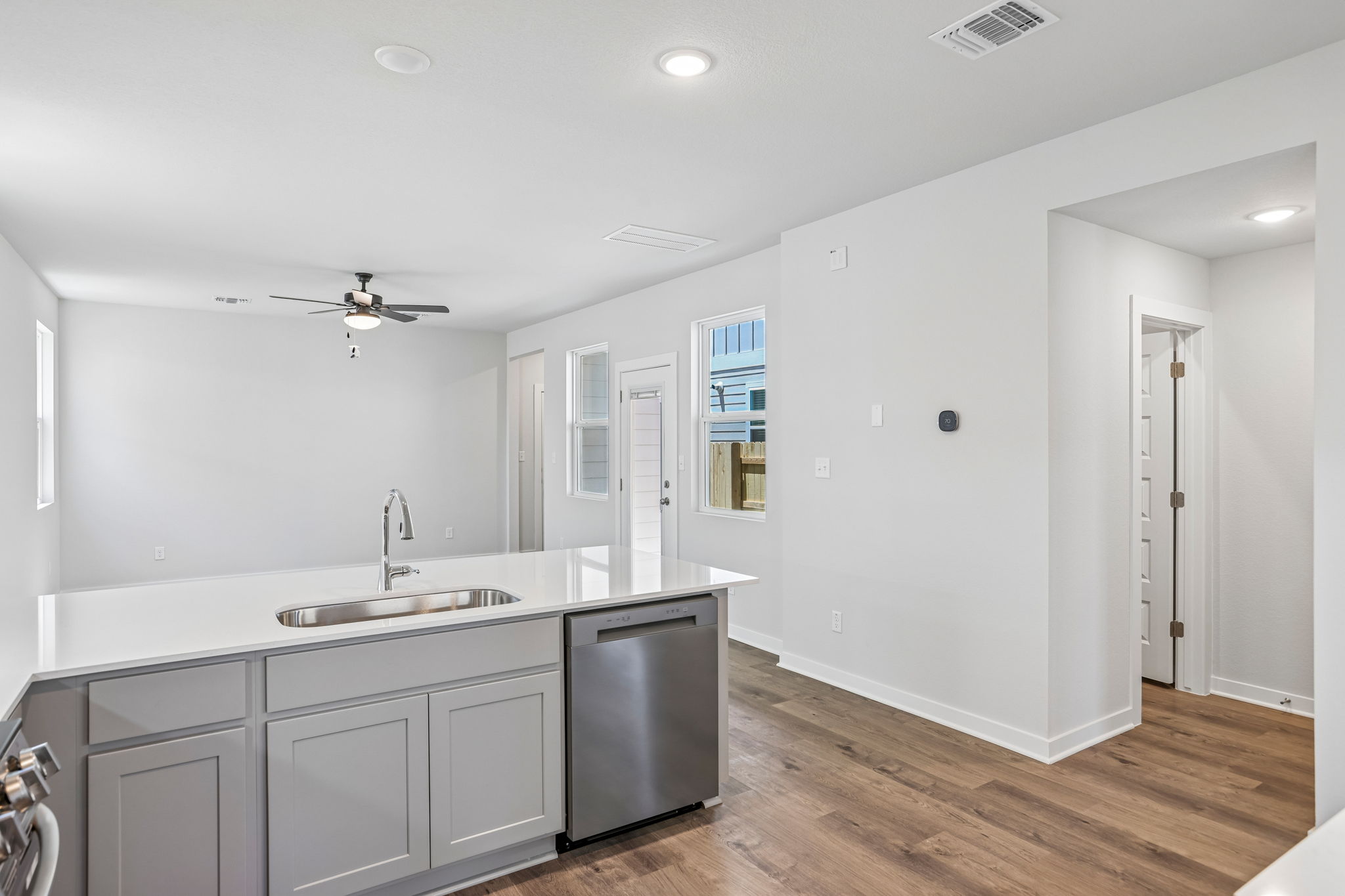 A kitchen with white cabinets.