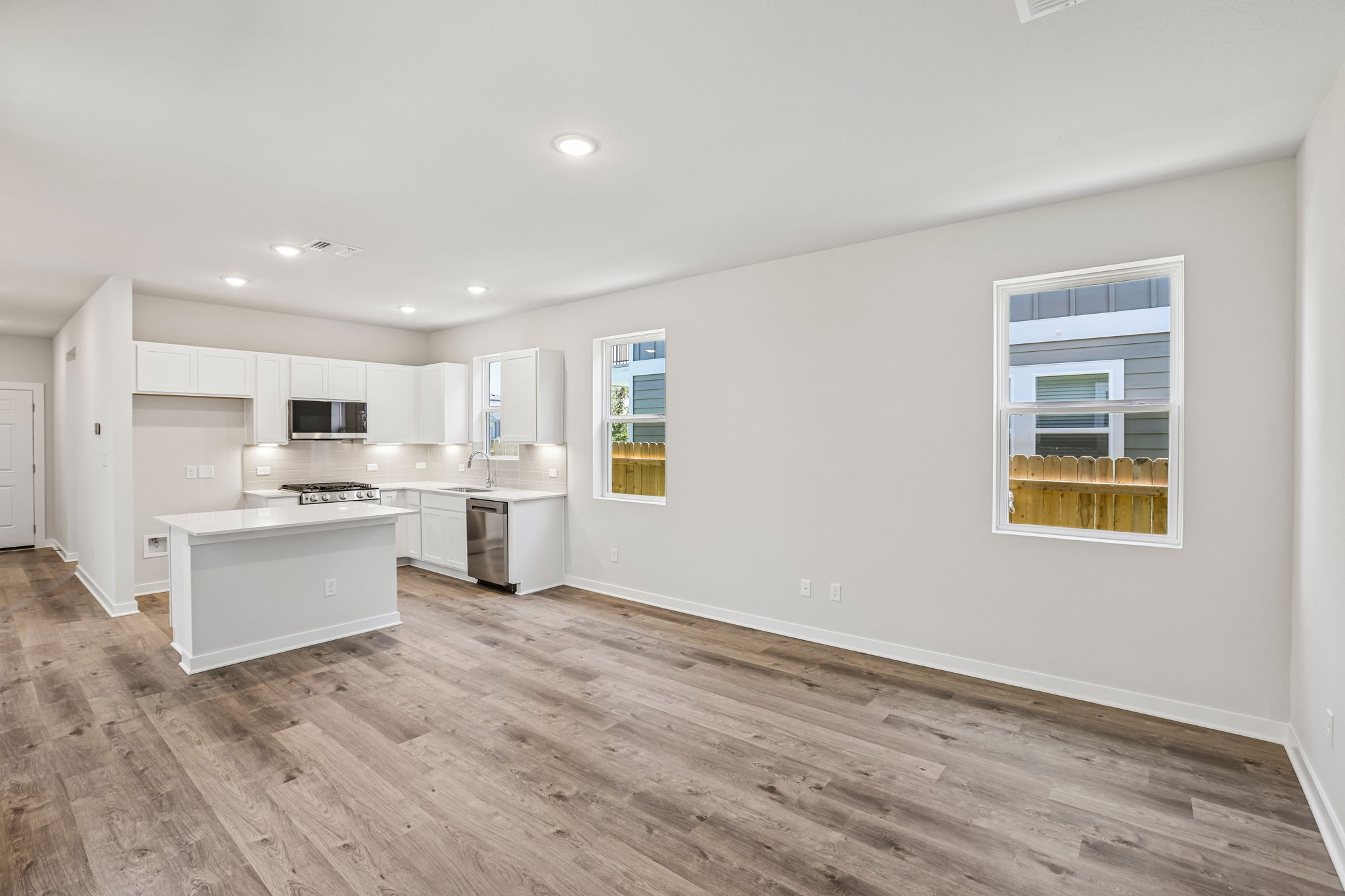 A kitchen with white cabinets.