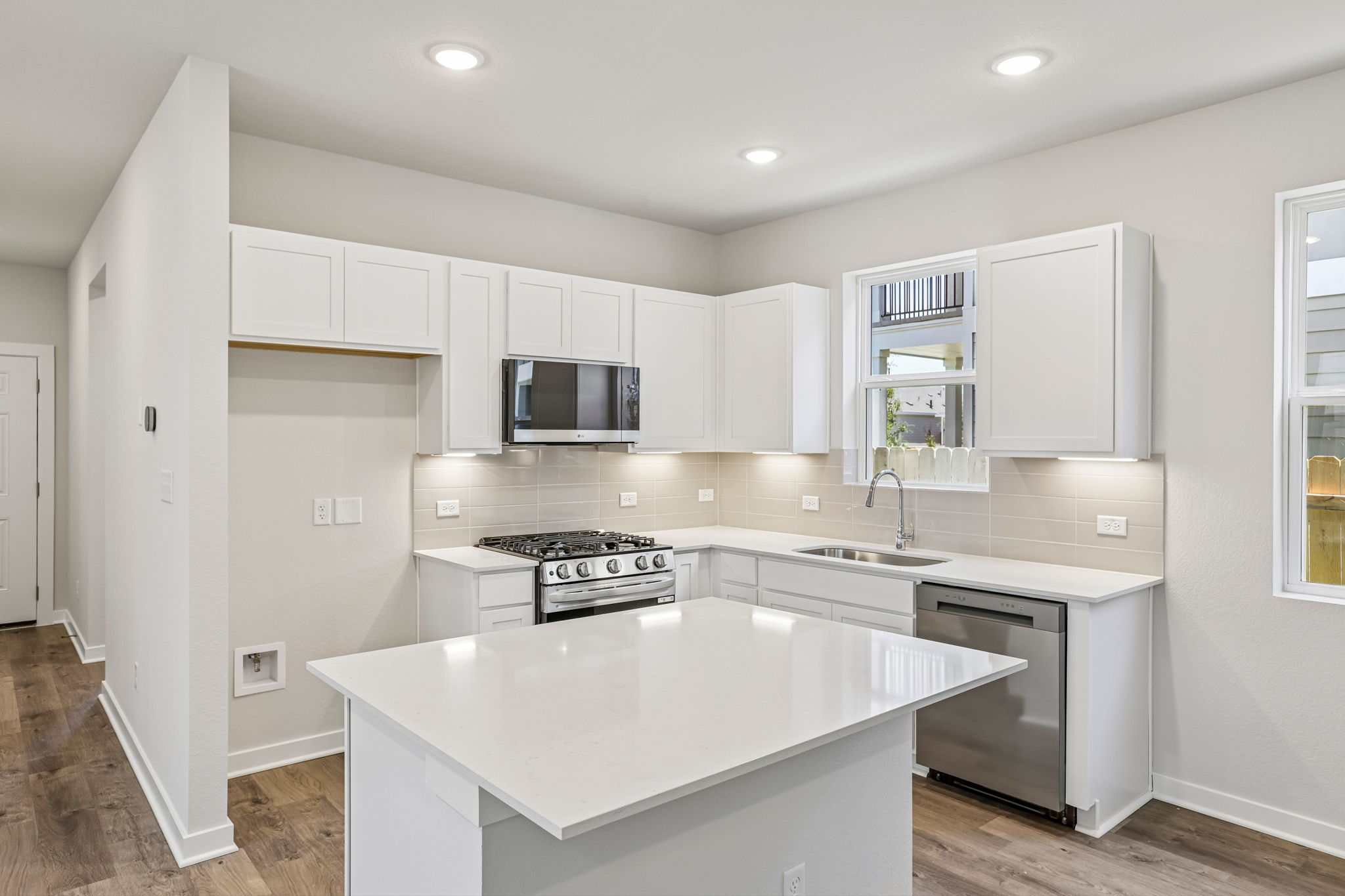 A kitchen with white cabinets.