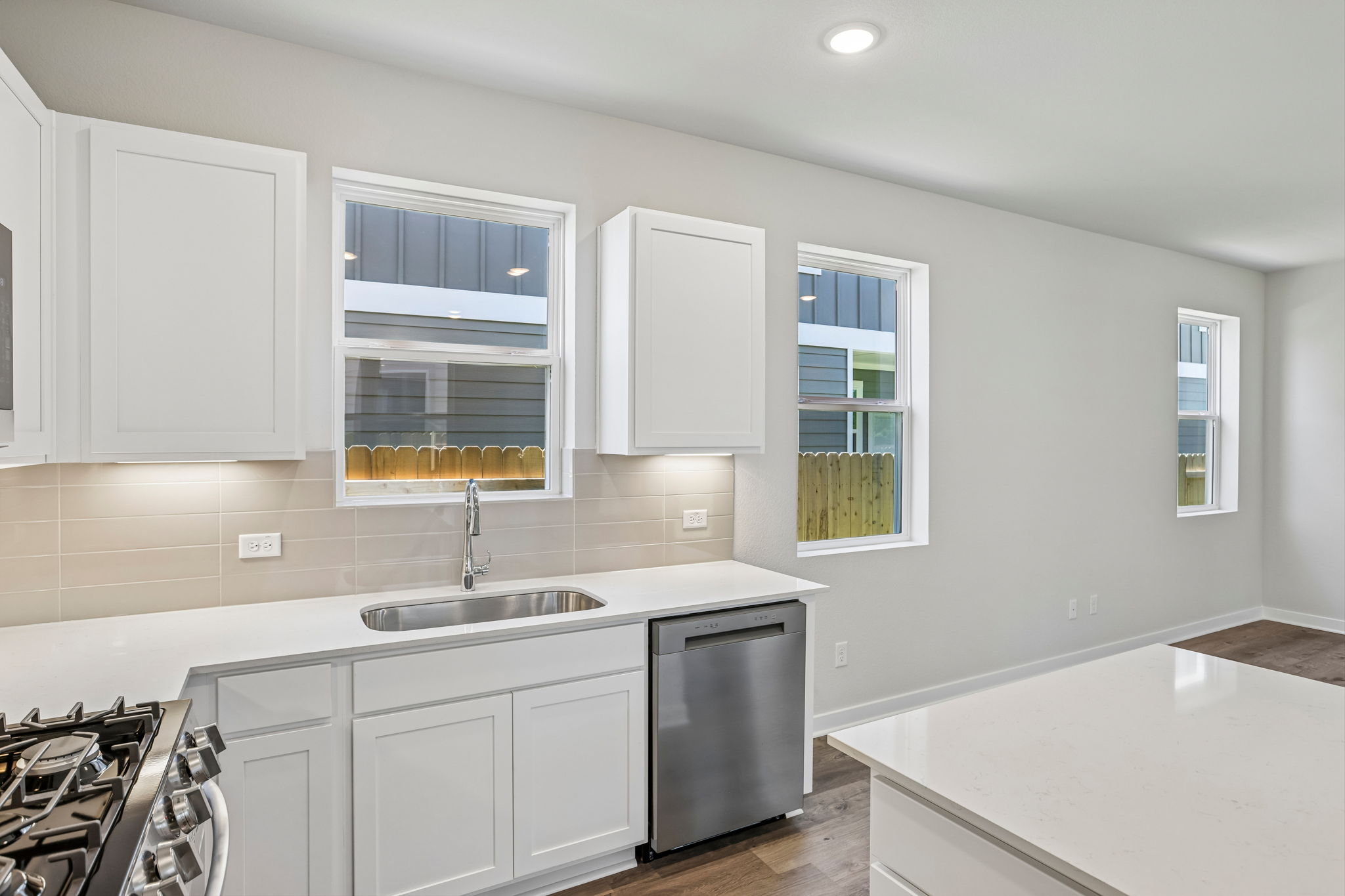 A kitchen with white cabinets.