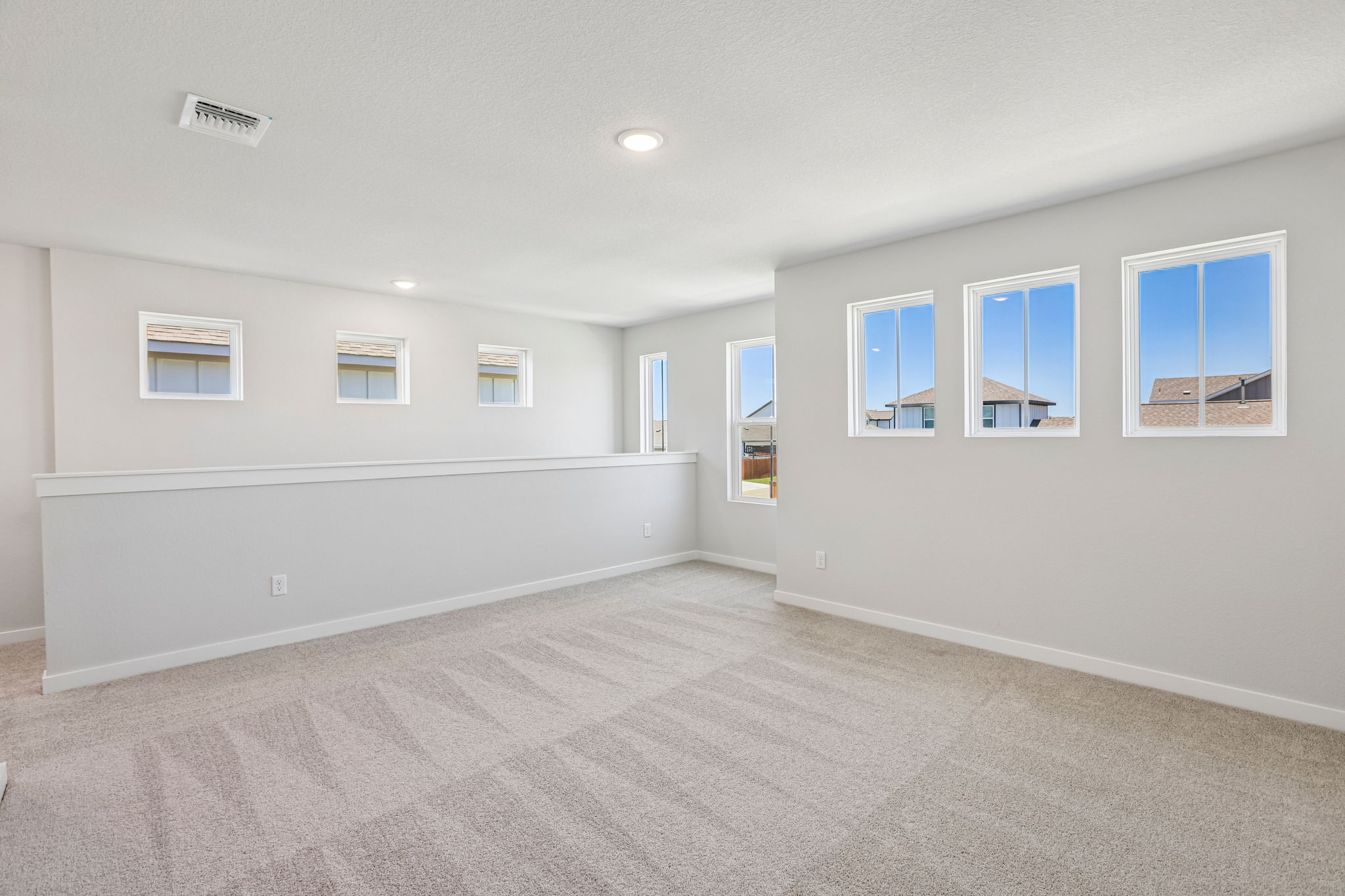 A room with white walls and windows.