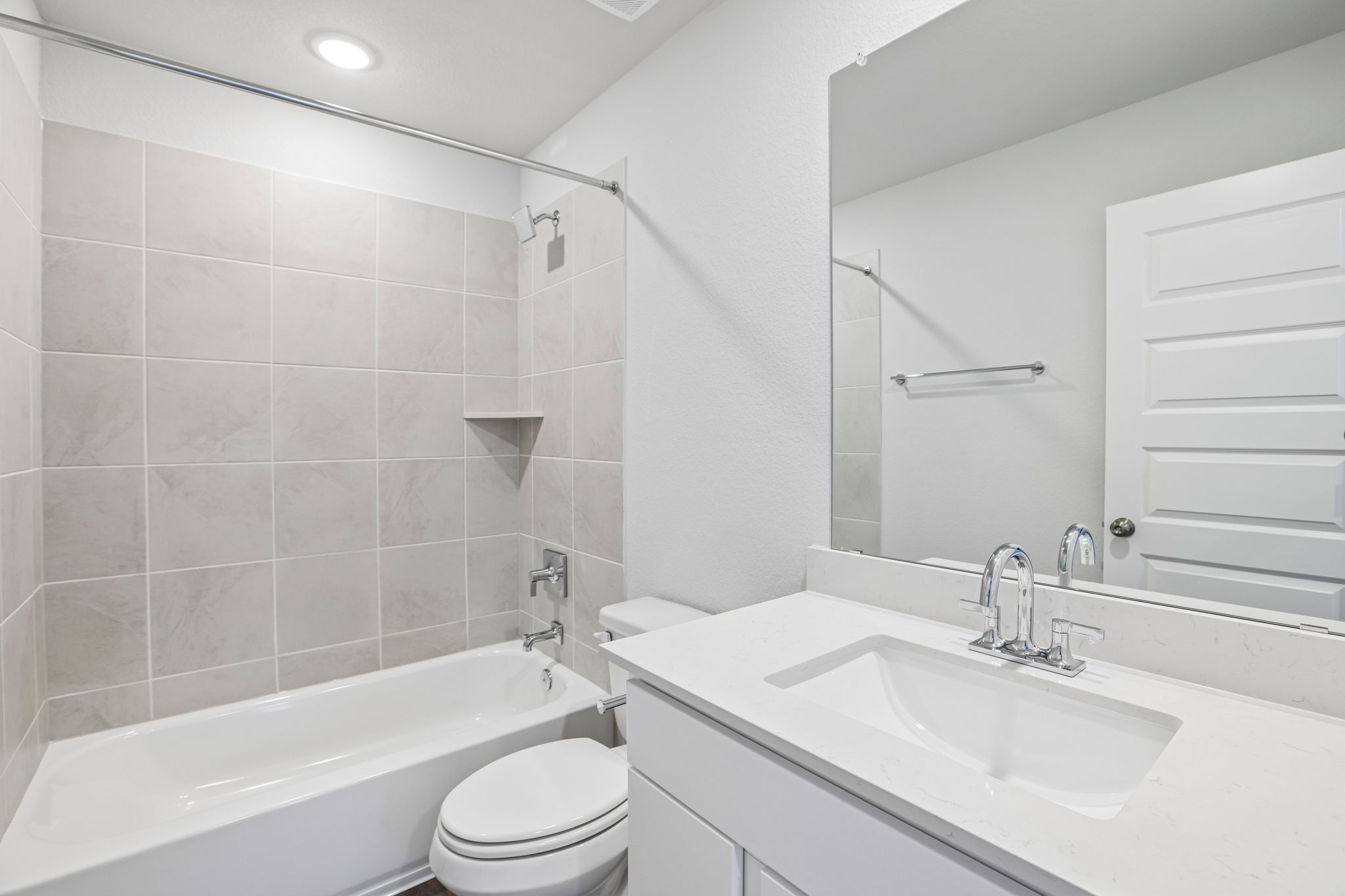 A bathroom with a tub sink and toilet.