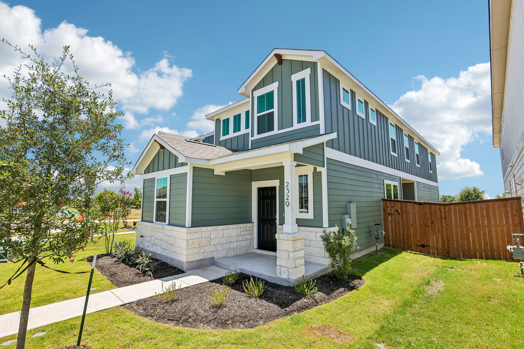 A house with a fence and yard.