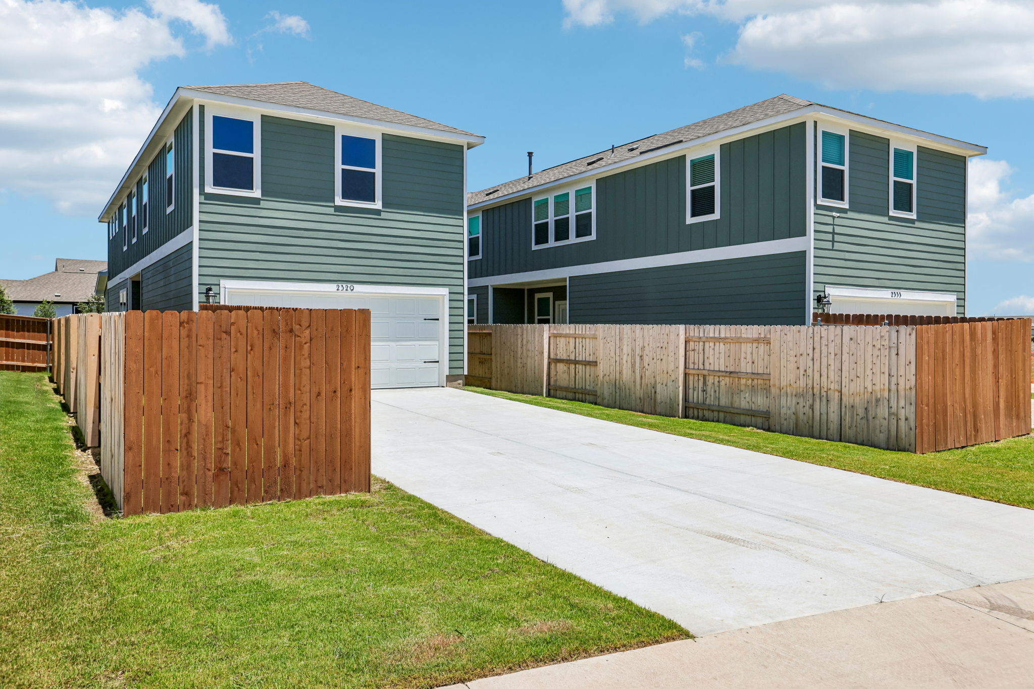 A house with a fence and grass.