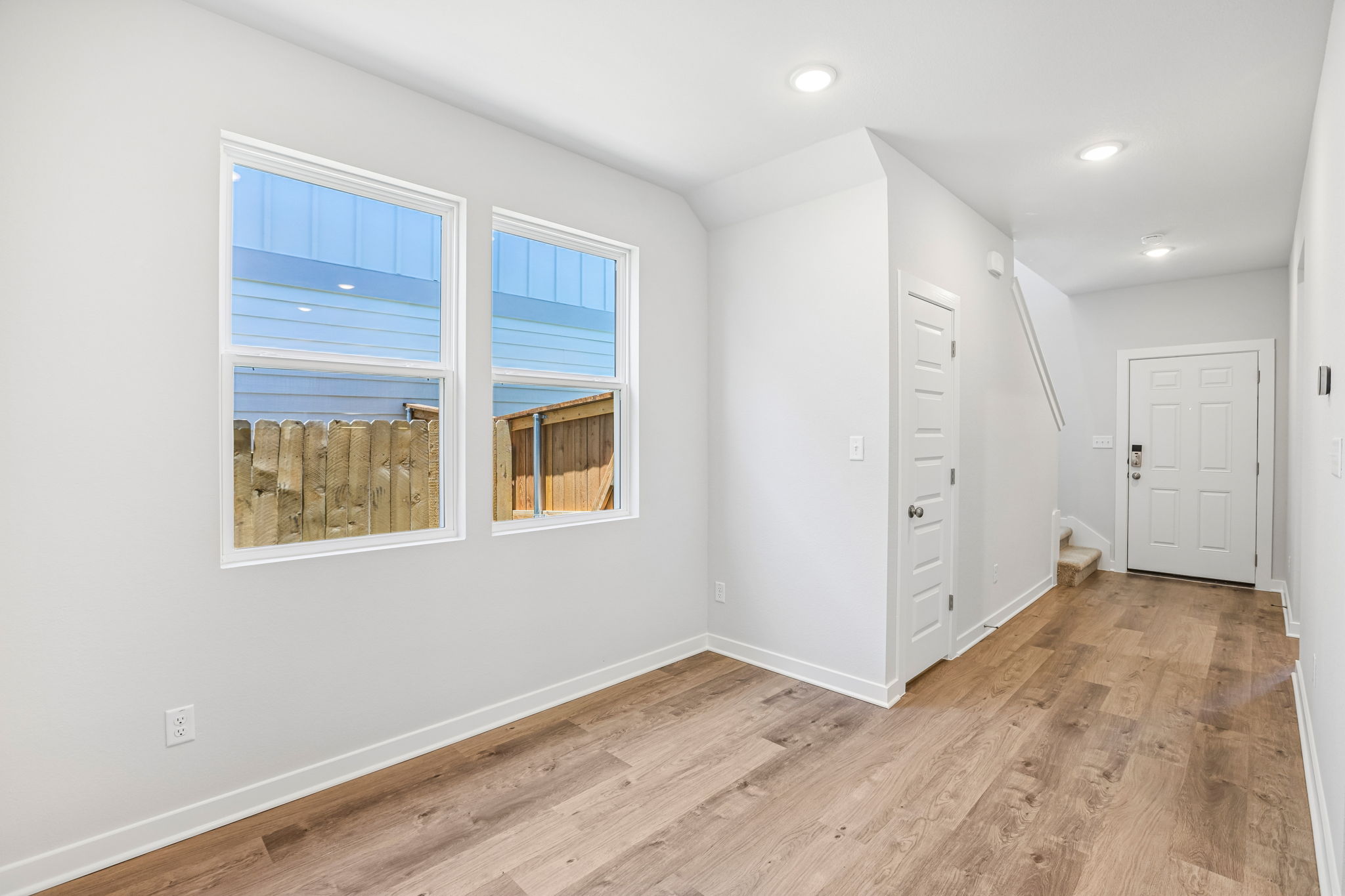 A room with a wood floor and white walls.