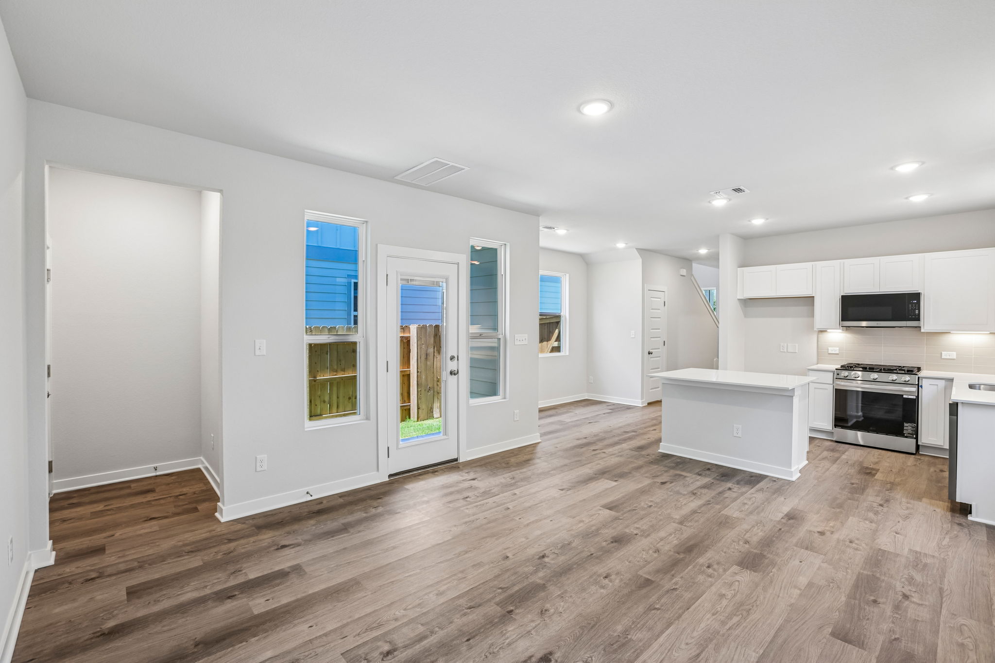 A kitchen with white cabinets.