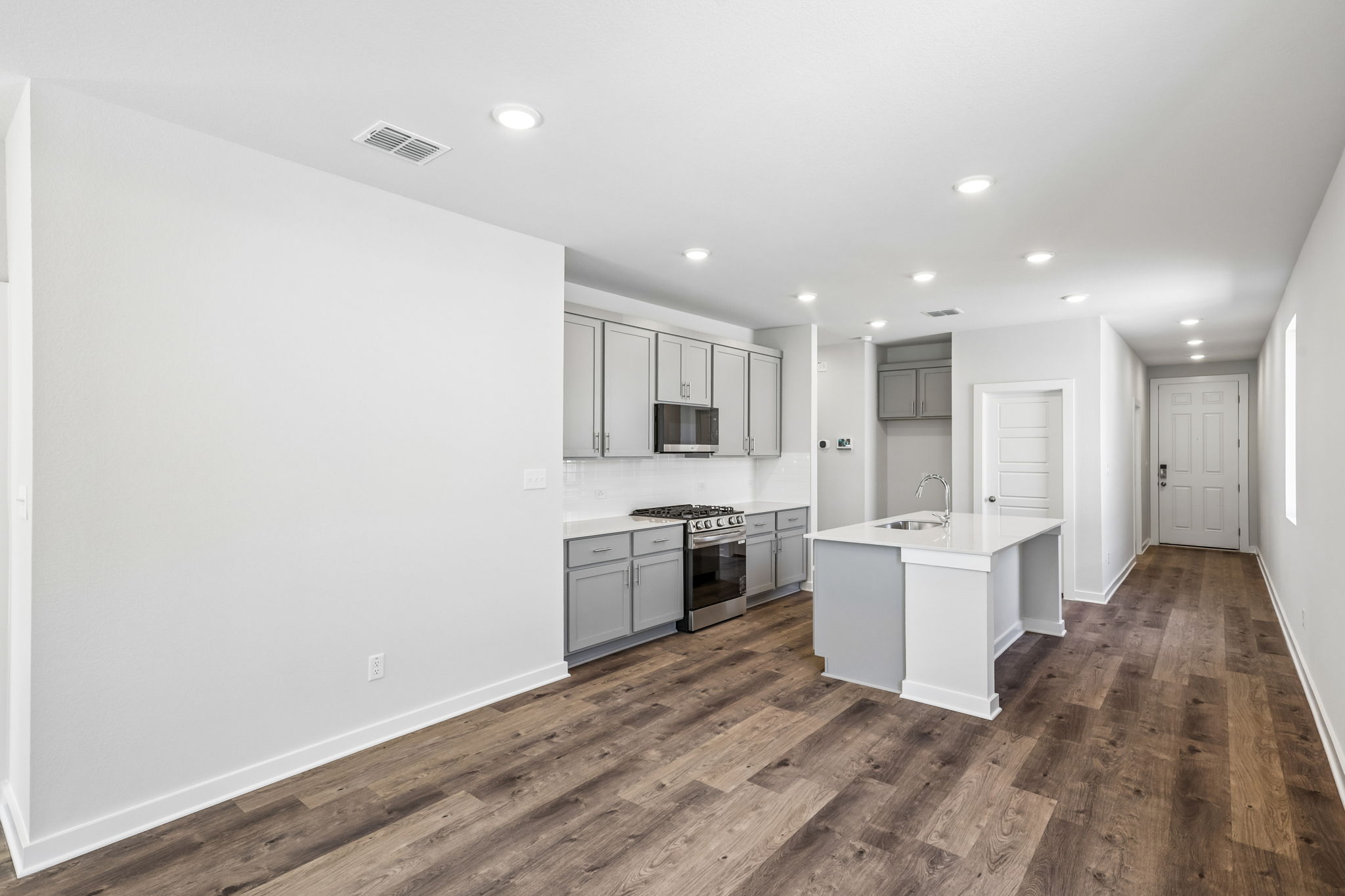A kitchen with white cabinets.