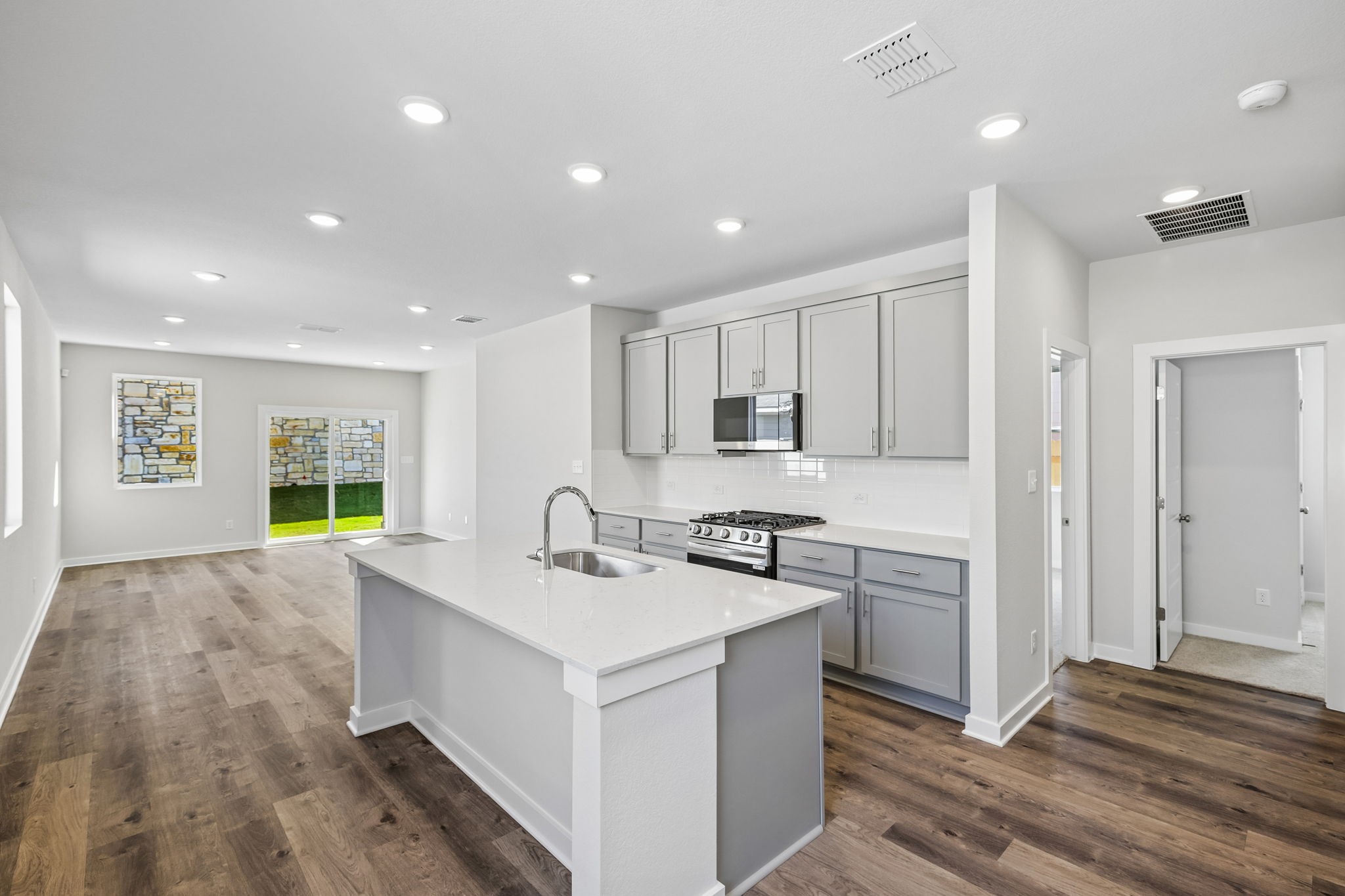 A kitchen with white cabinets.