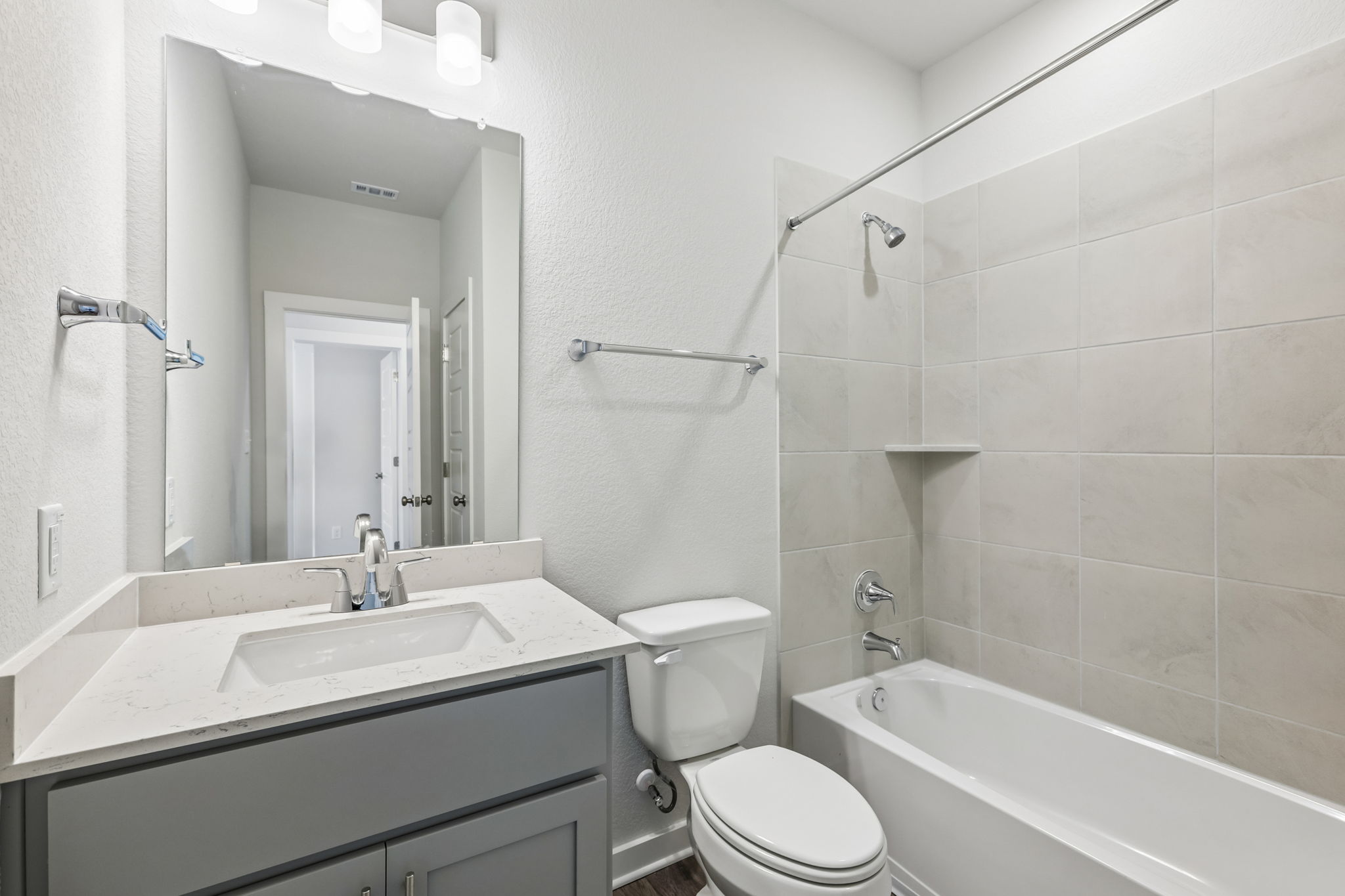 A bathroom with a tub sink and toilet.