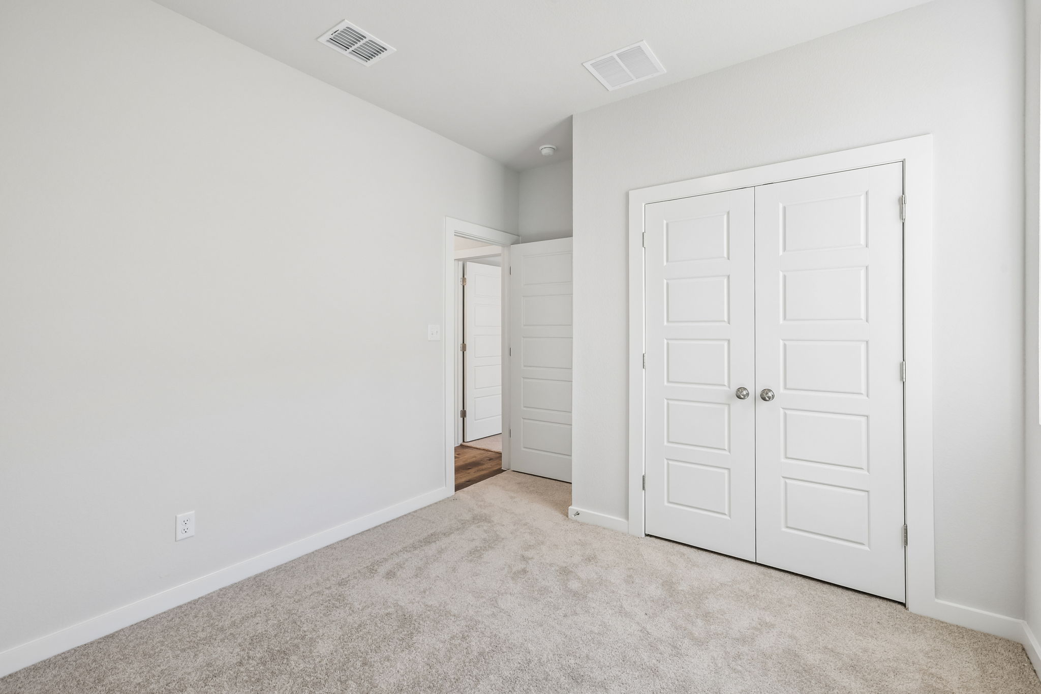 A hallway with white doors.