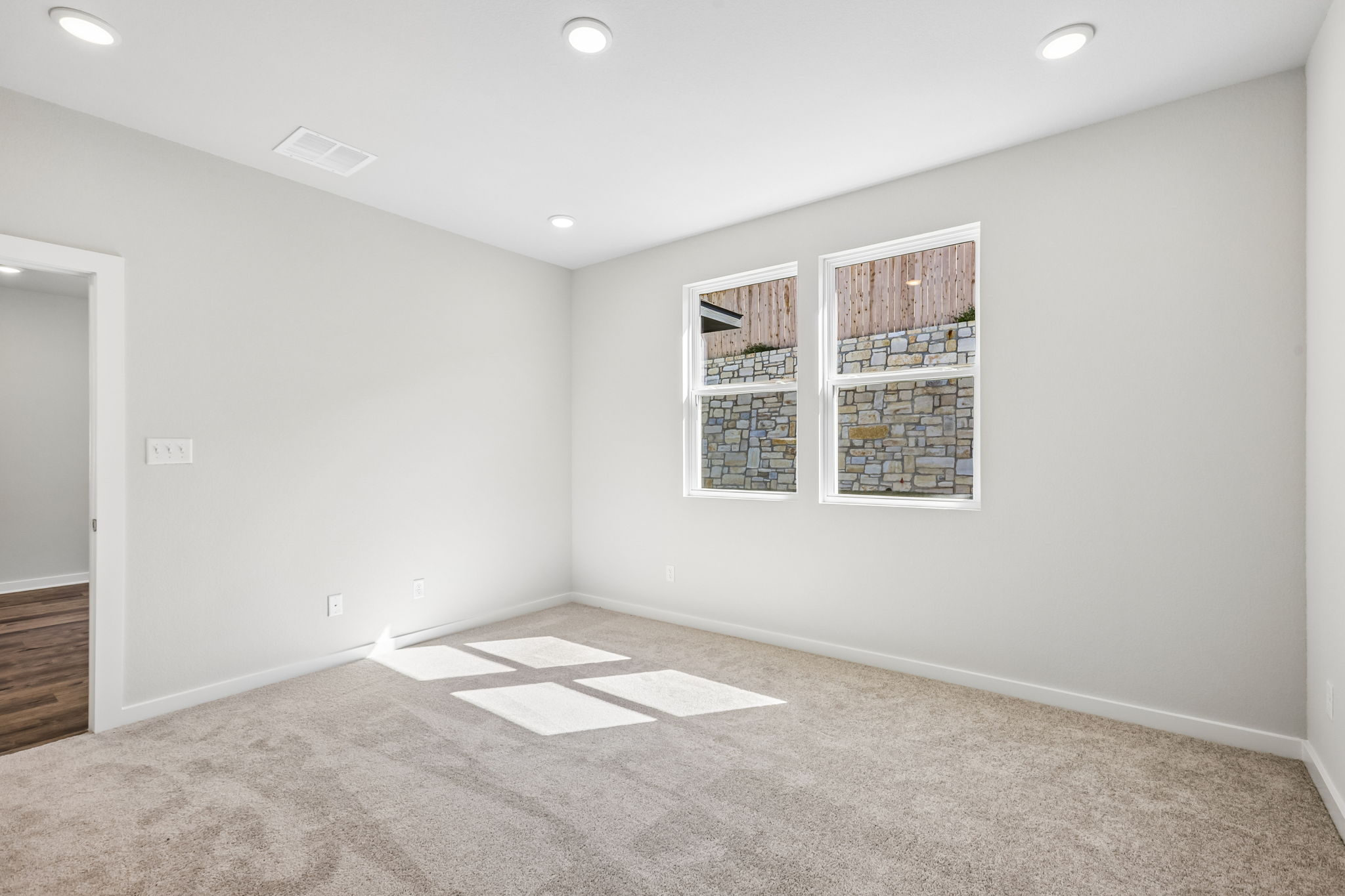 A room with a carpet and a rug.