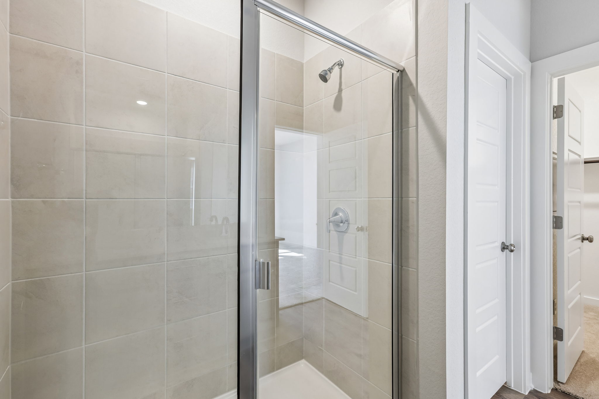 A shower with a glass door.