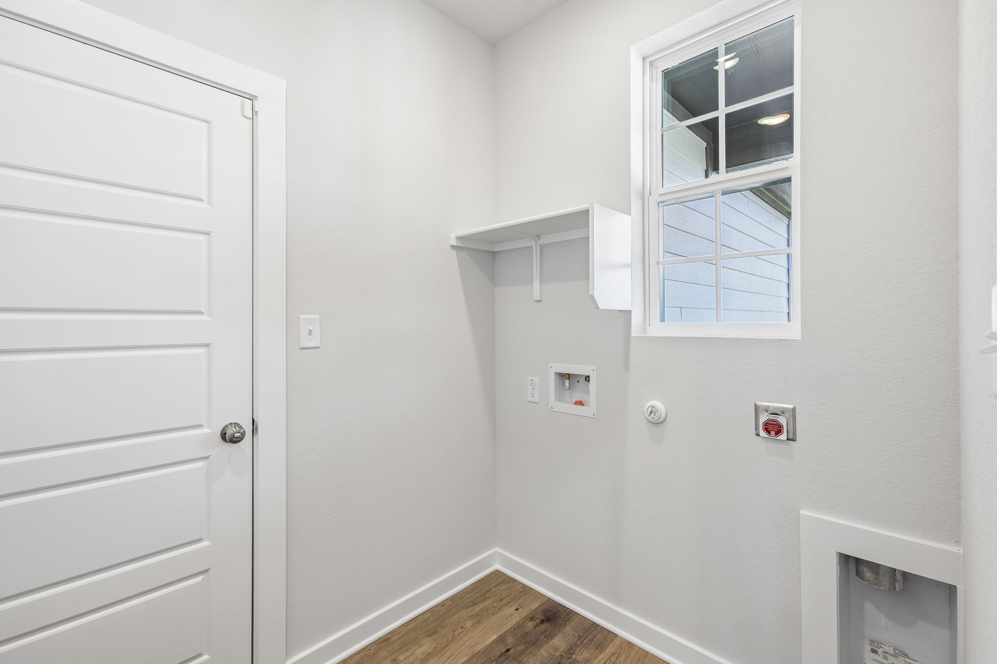 A white room with a window.