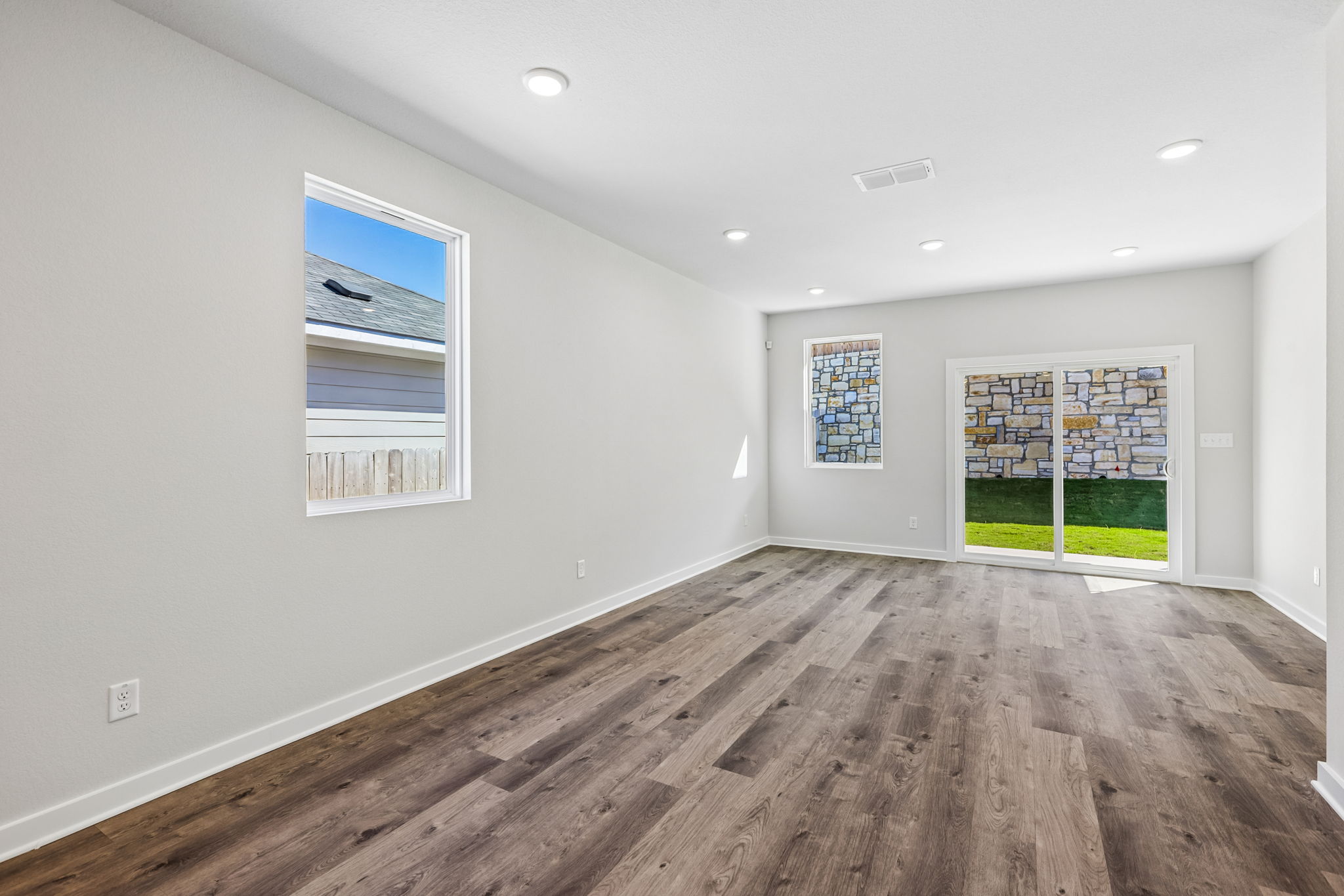 A room with a wood floor and a window with a wood floor.