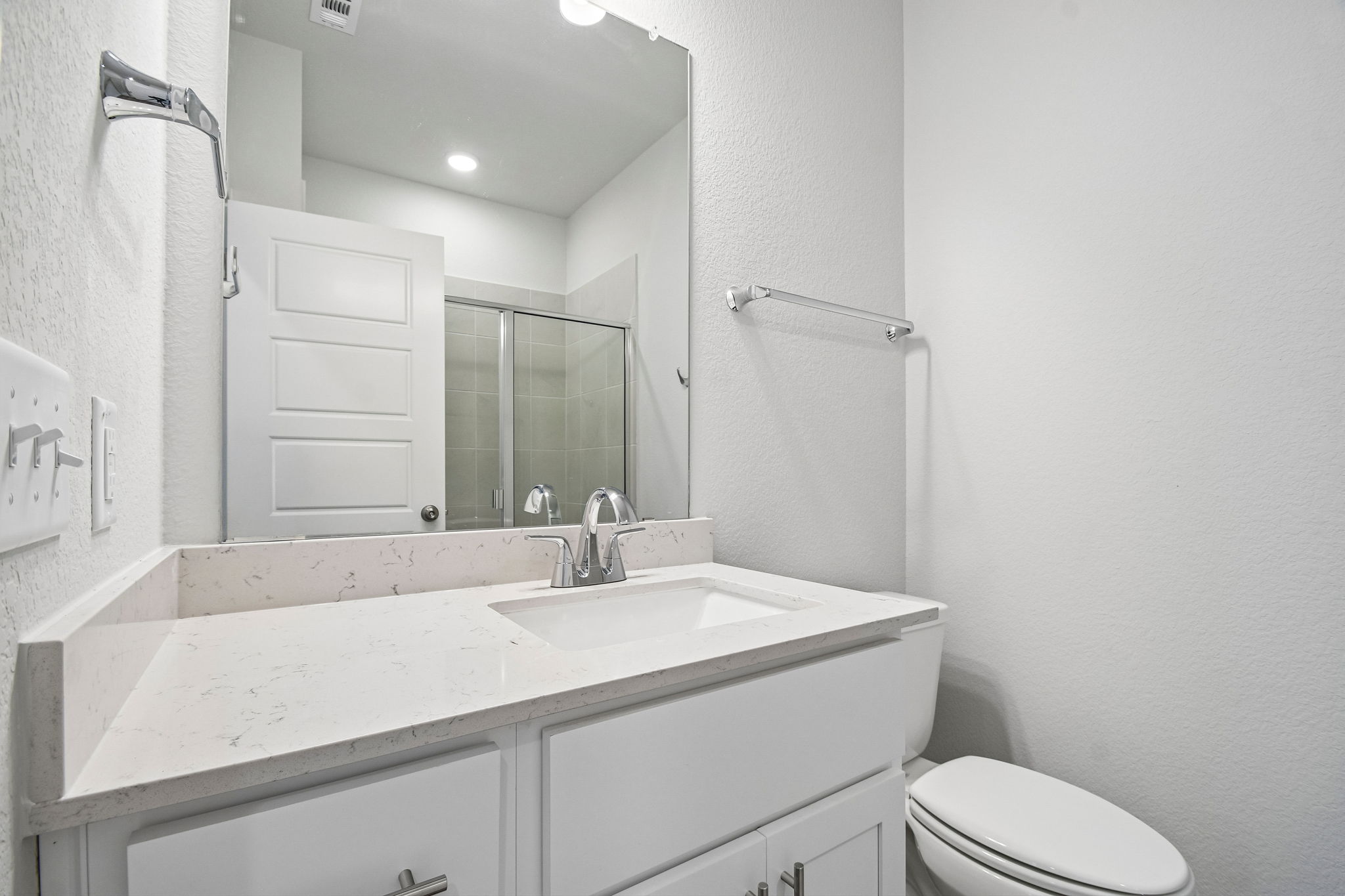 A bathroom with a sink and a toilet.