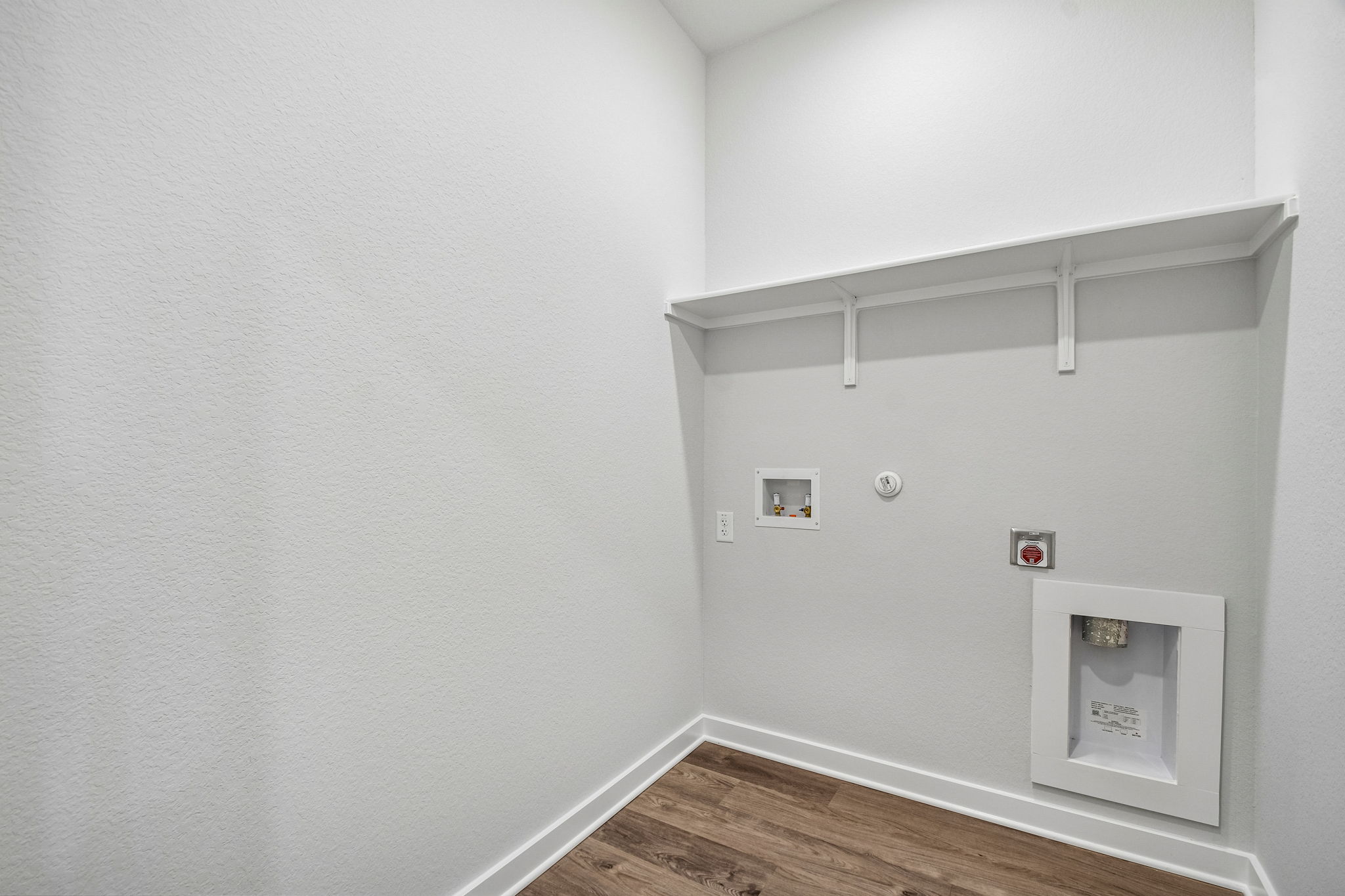 A white wall with a light on it.