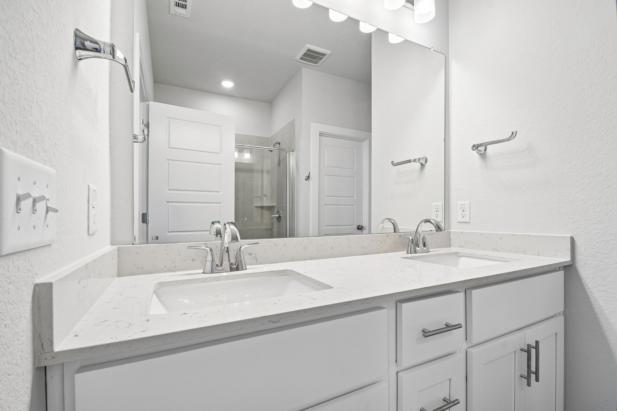 A bathroom with a large mirror.