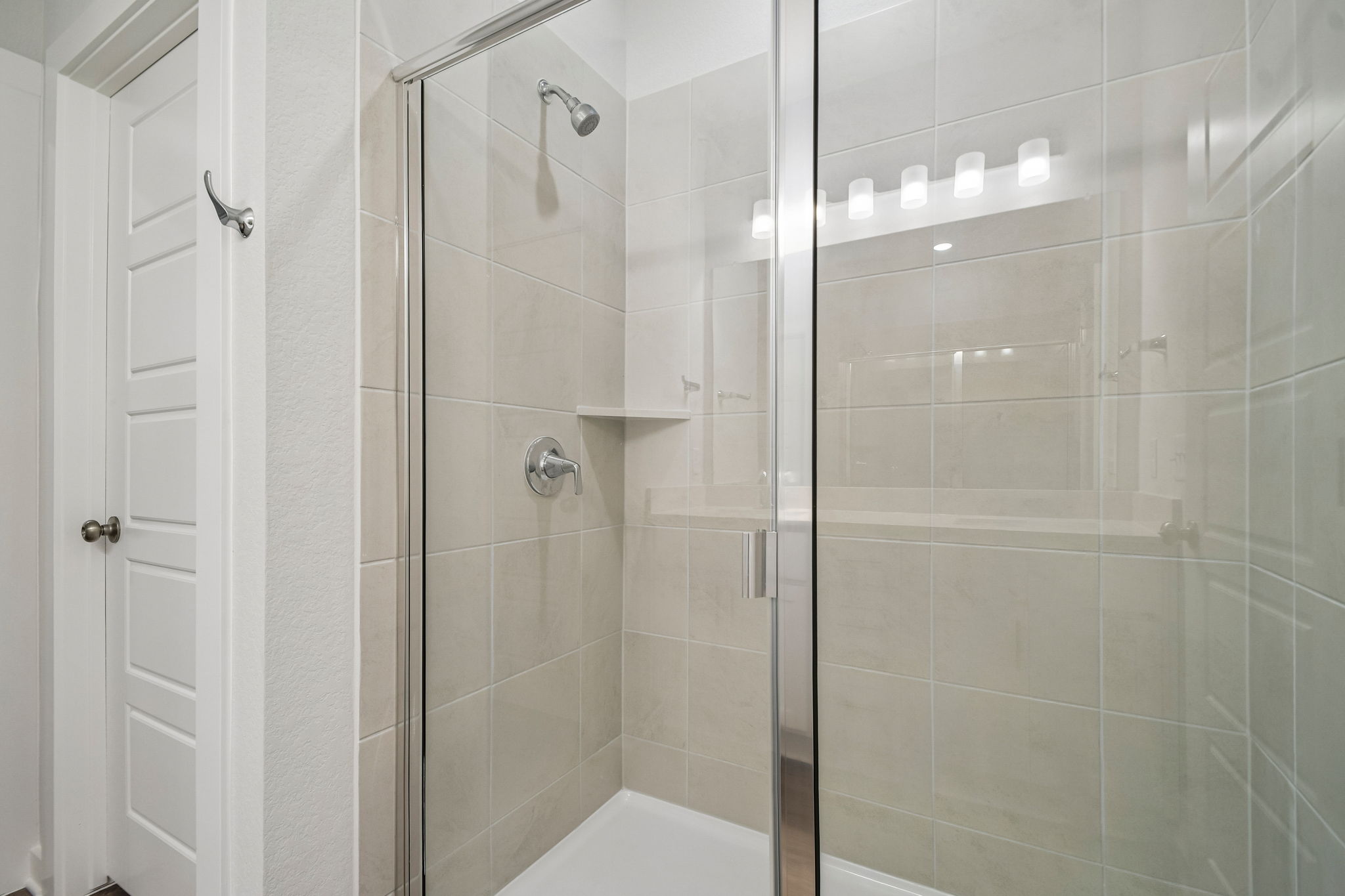 A shower with a glass door.