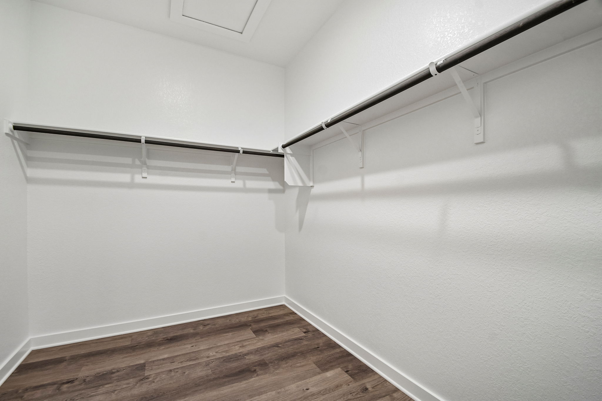 A white room with a wood floor.