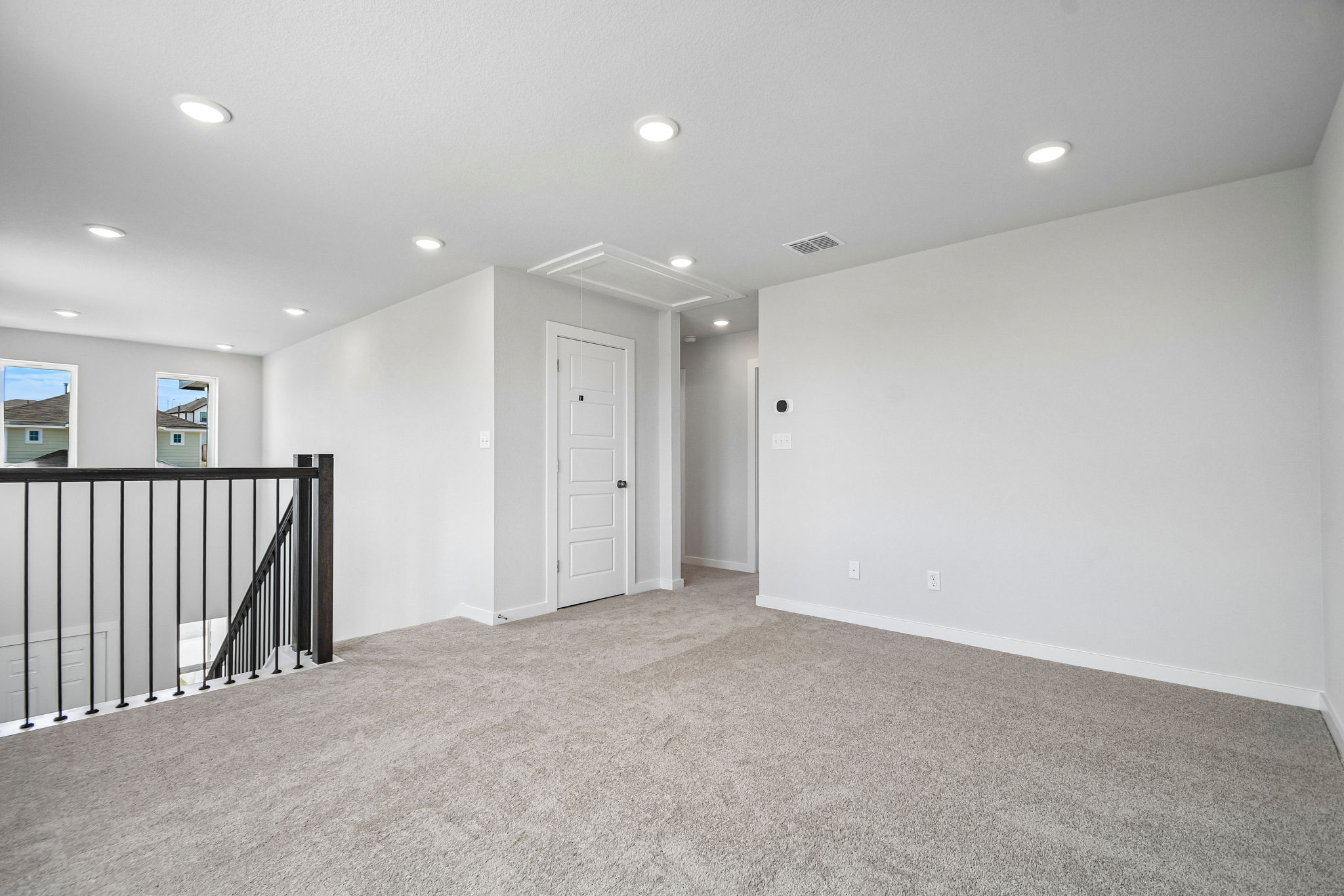 A room with a staircase and a railing.