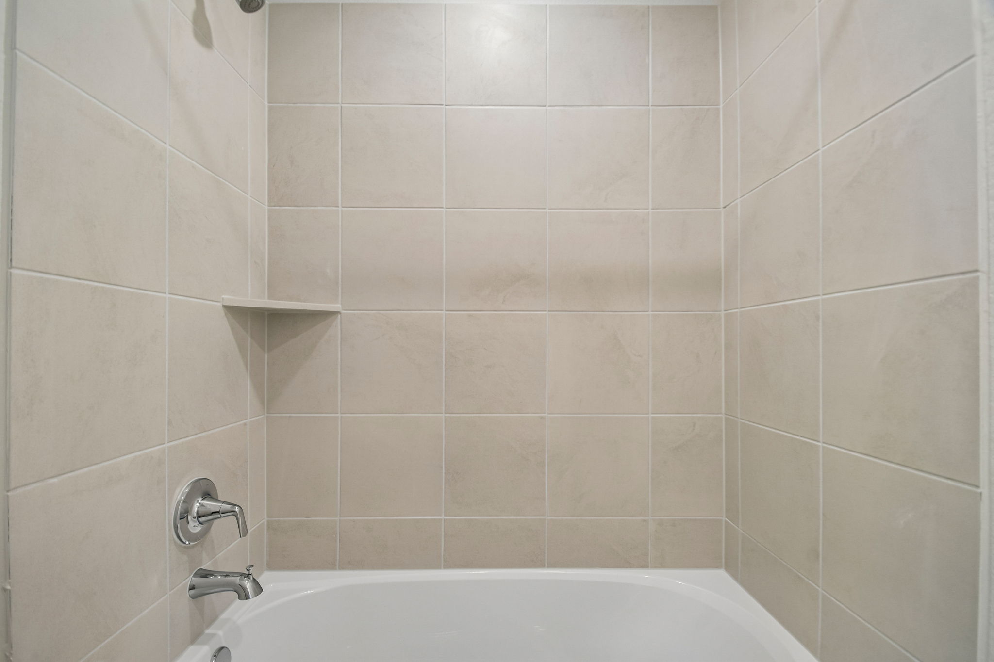 A bathtub in a bathroom.
