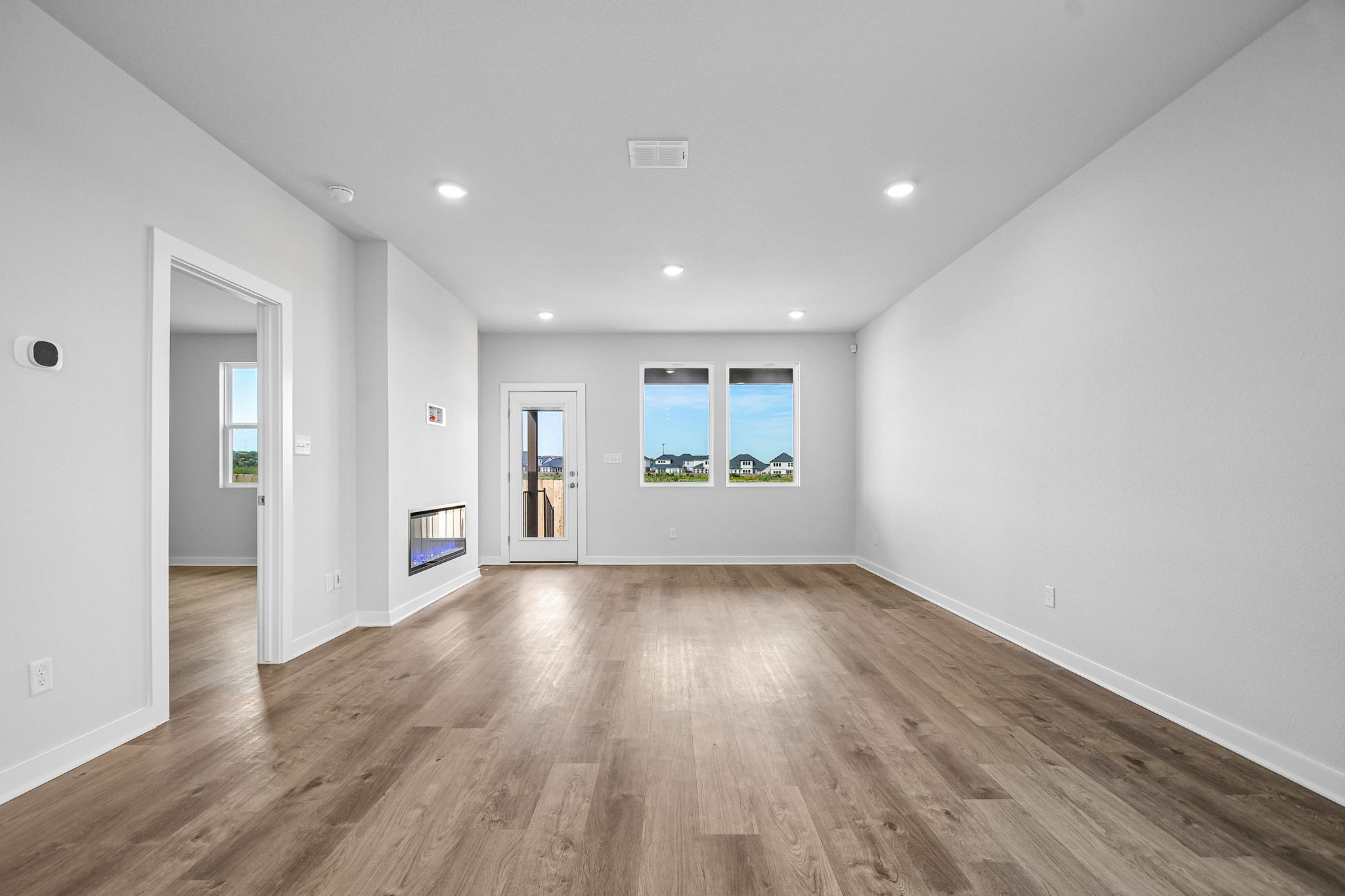 A room with a wood floor and white walls.