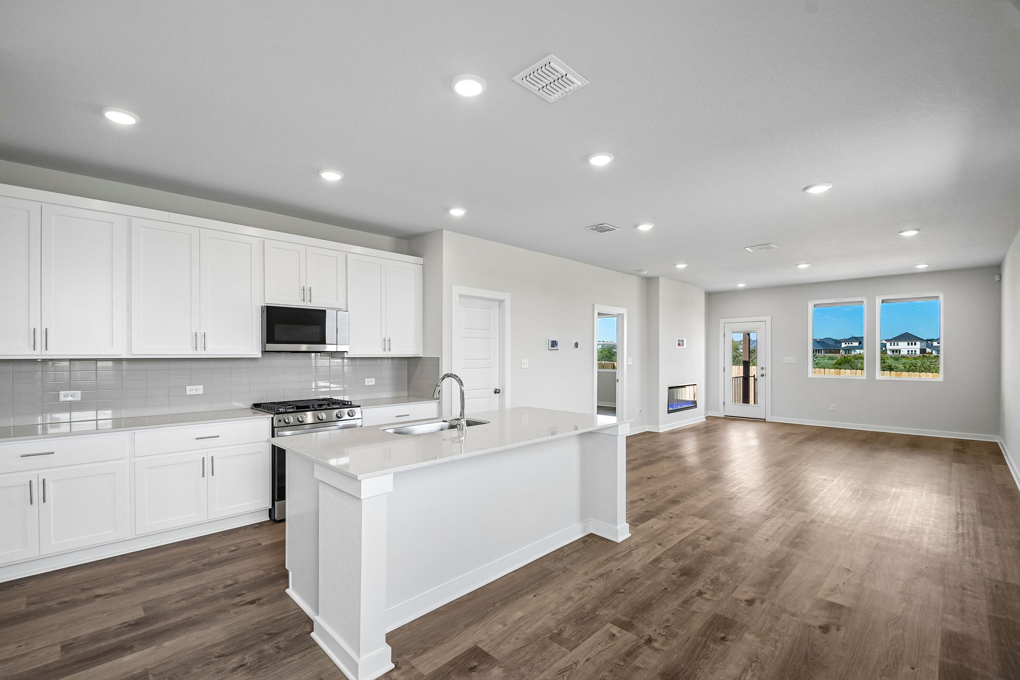 A kitchen with white cabinets.