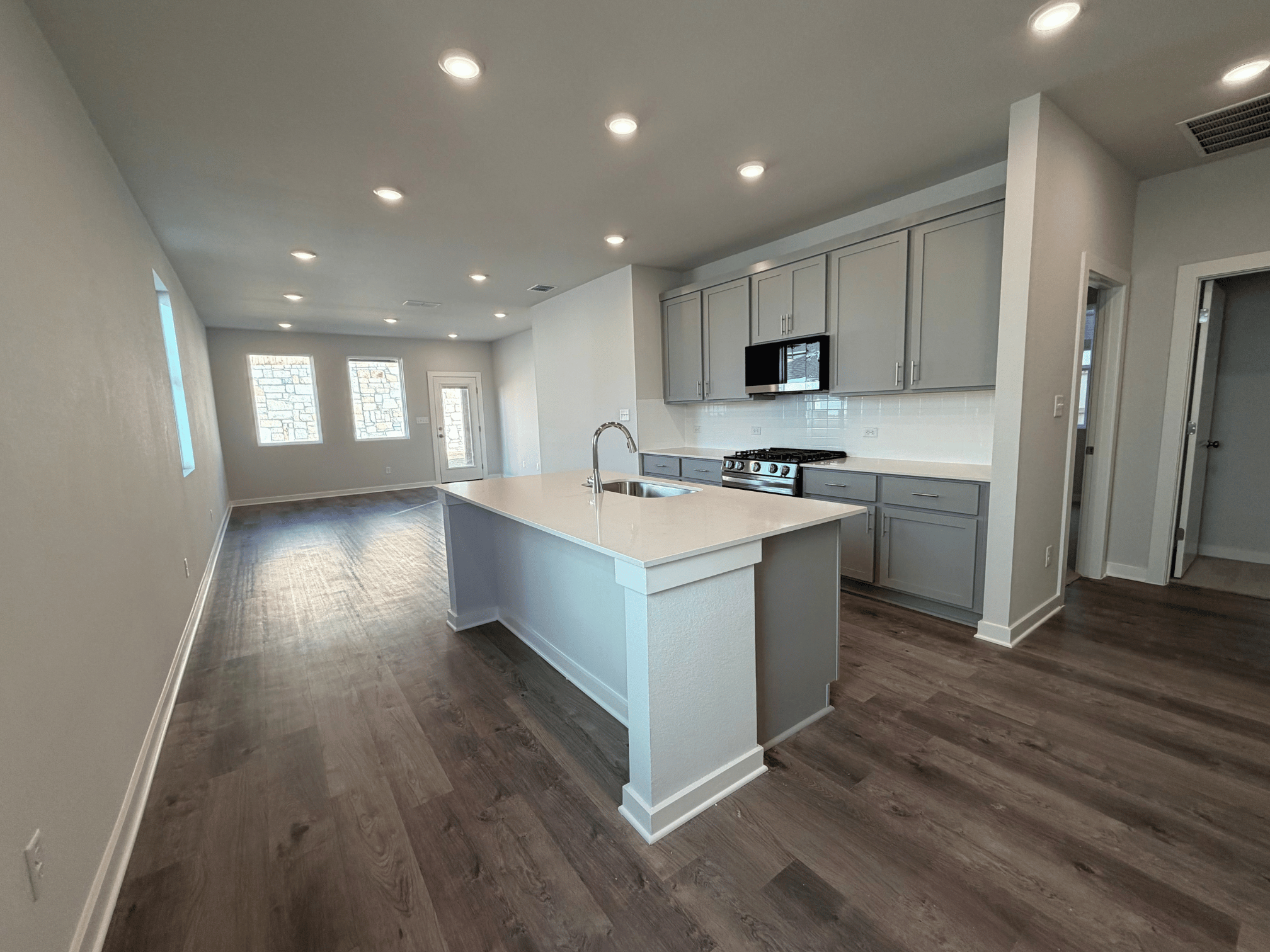 A kitchen with white cabinets.
