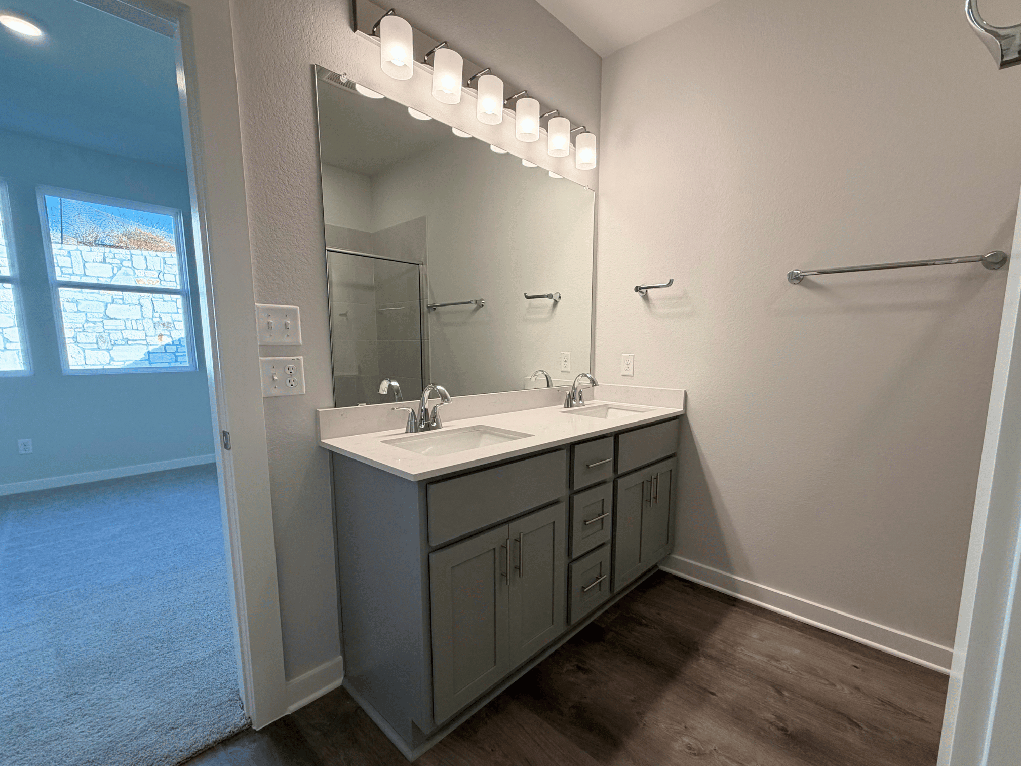 A bathroom with a large mirror.