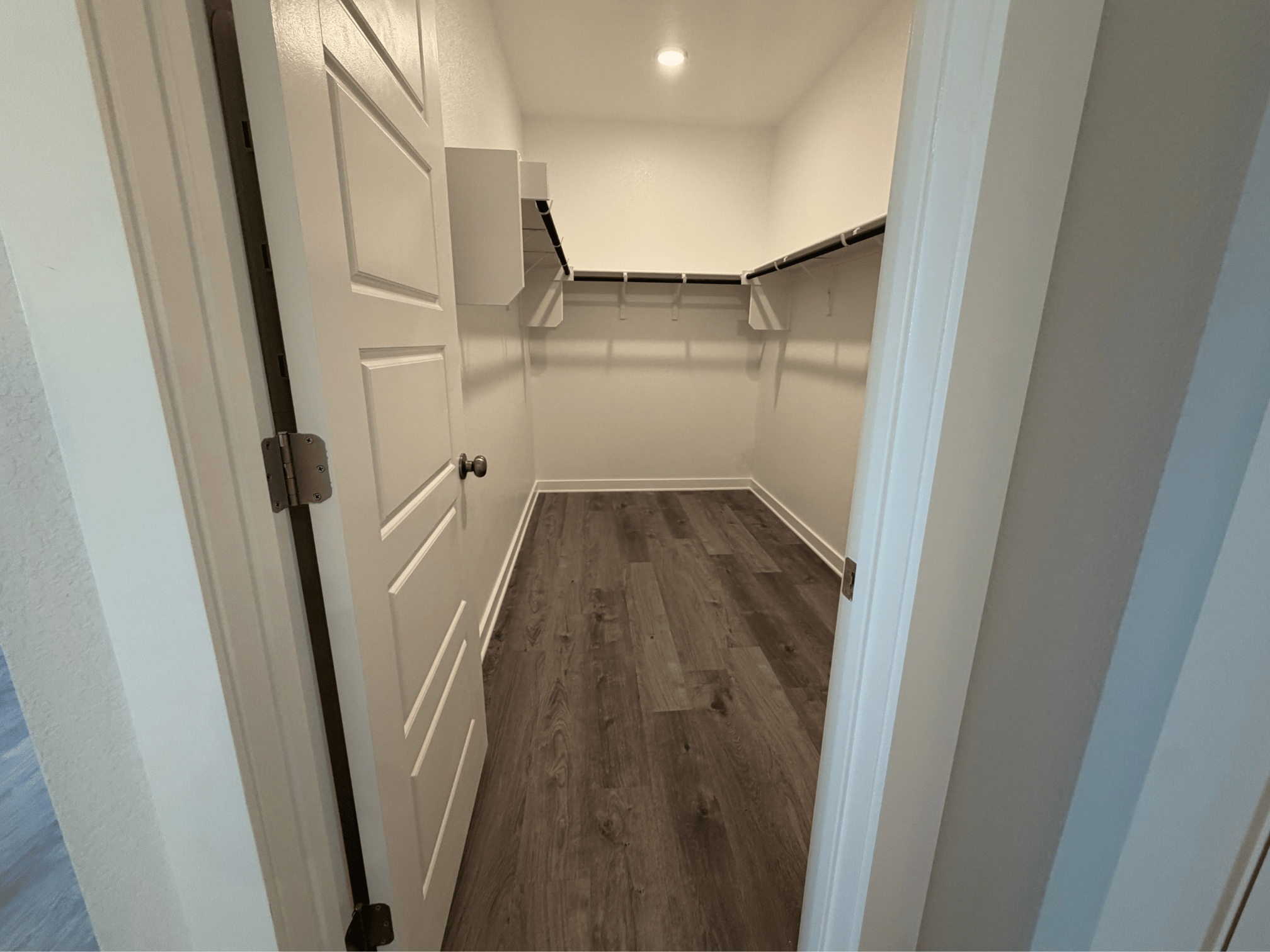 A hallway with white doors.