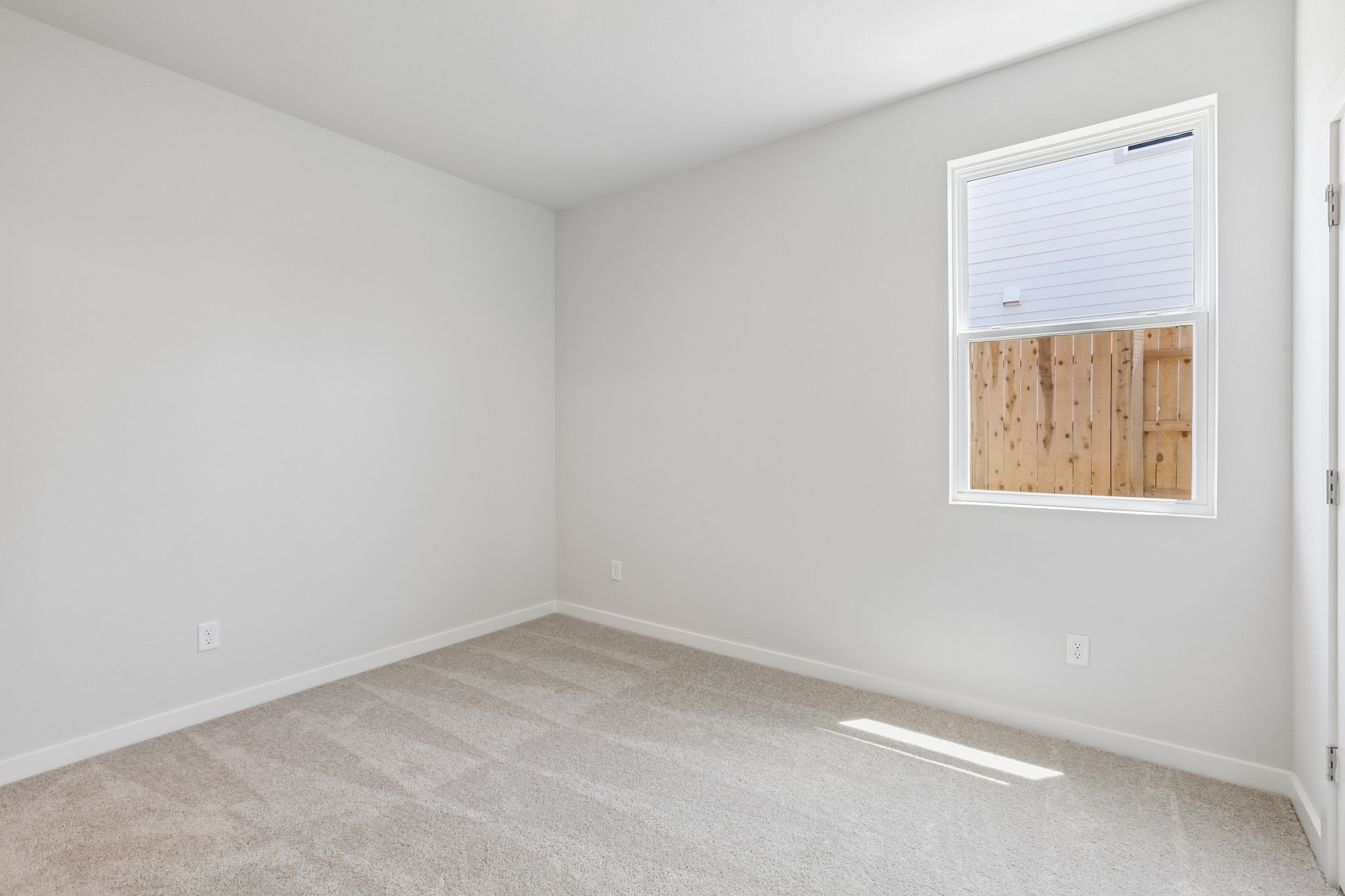 A room with a window and a vent.