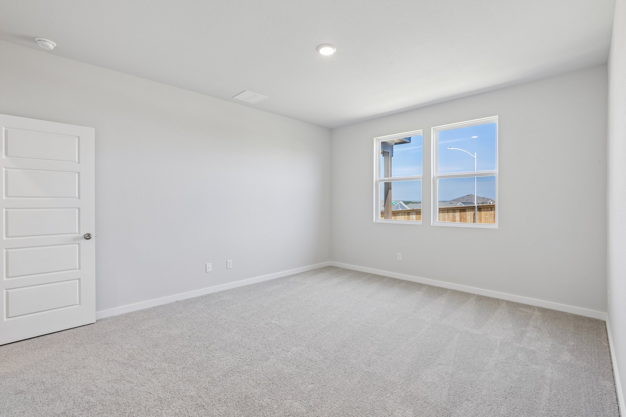 A room with a white door and a window with a white door.
