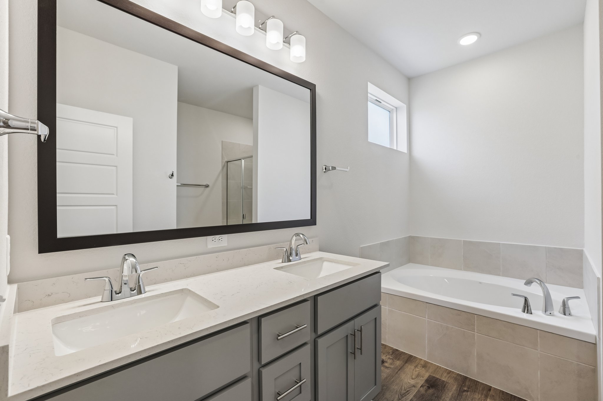 A bathroom with a large mirror.