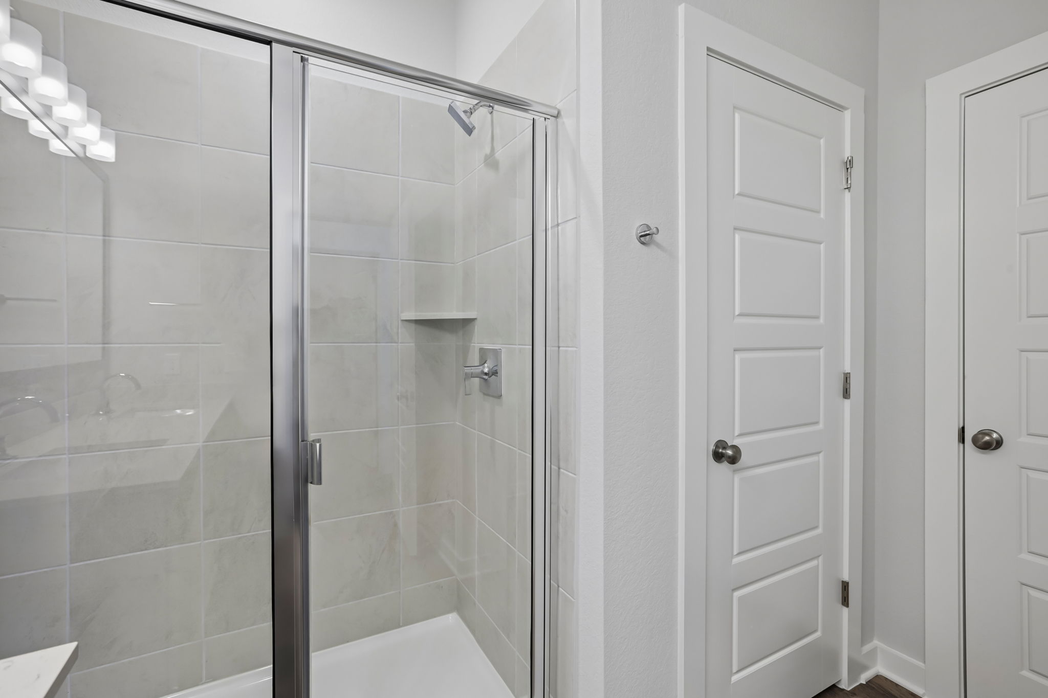 A shower with glass doors.