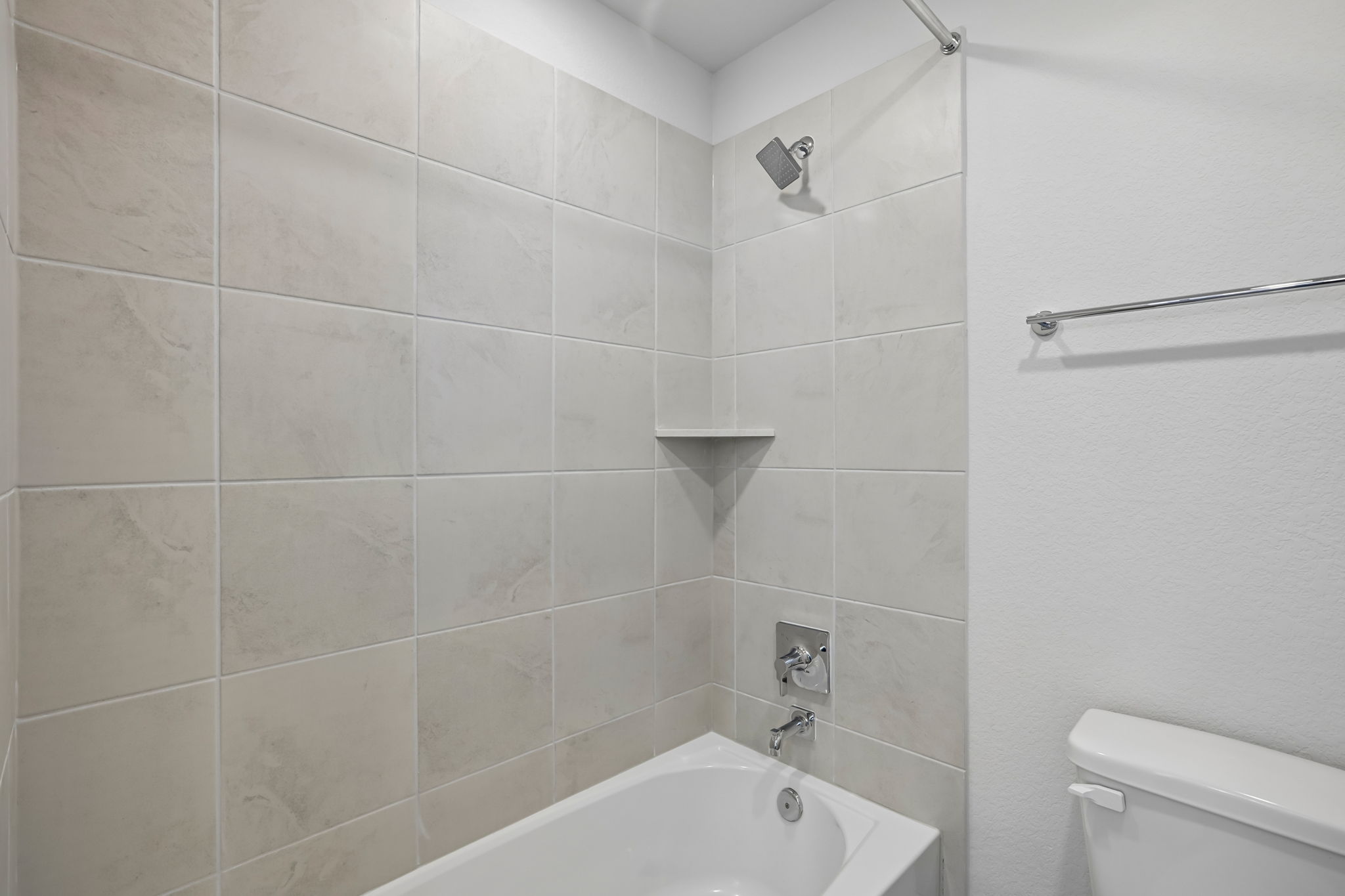 A bathroom with a bathtub and toilet.