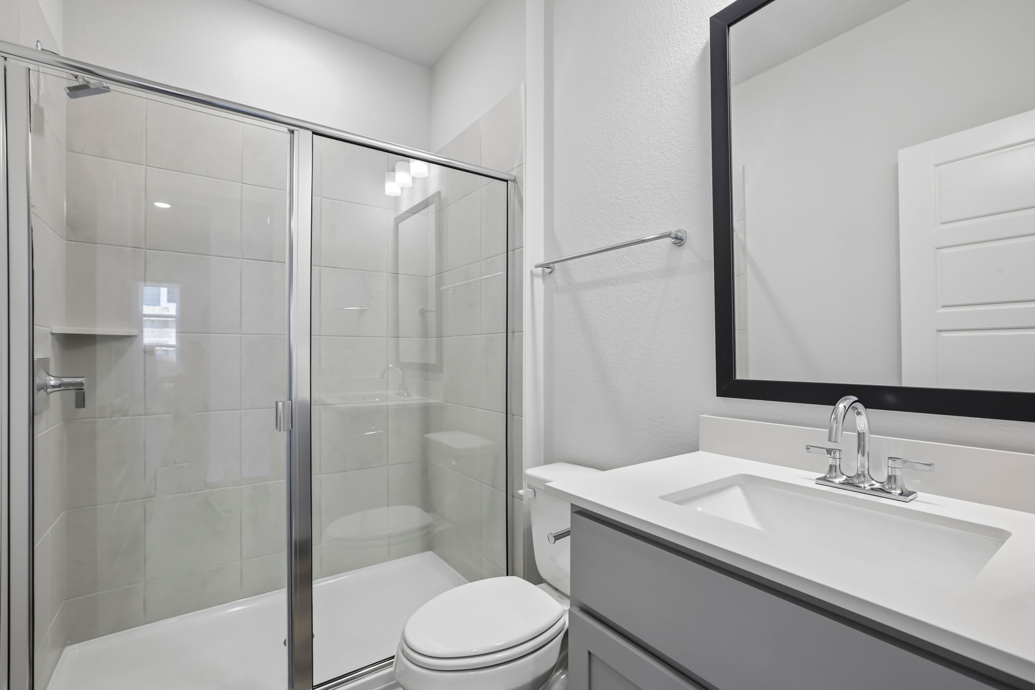 A bathroom with a glass shower.
