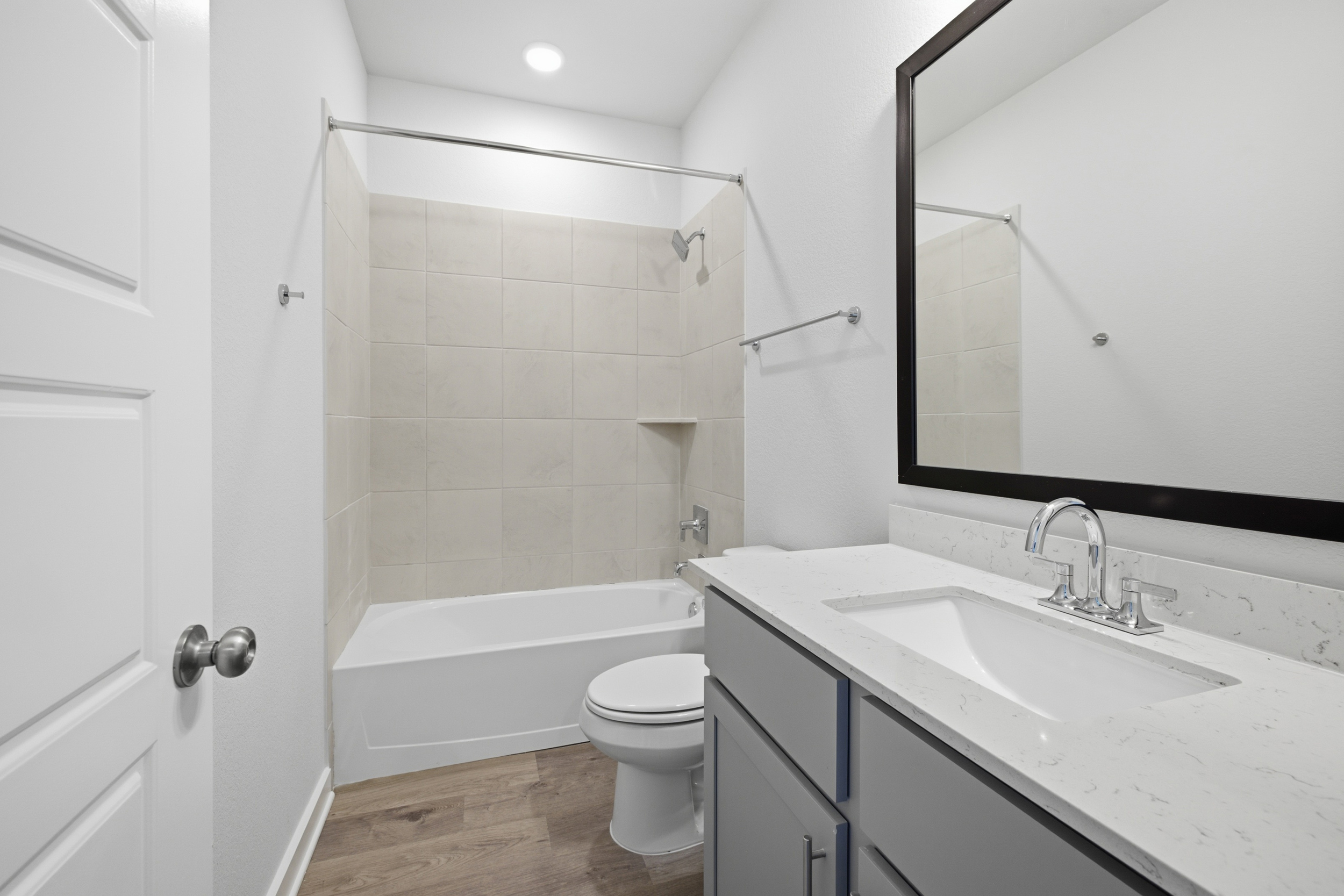 A bathroom with a tub sink and toilet.