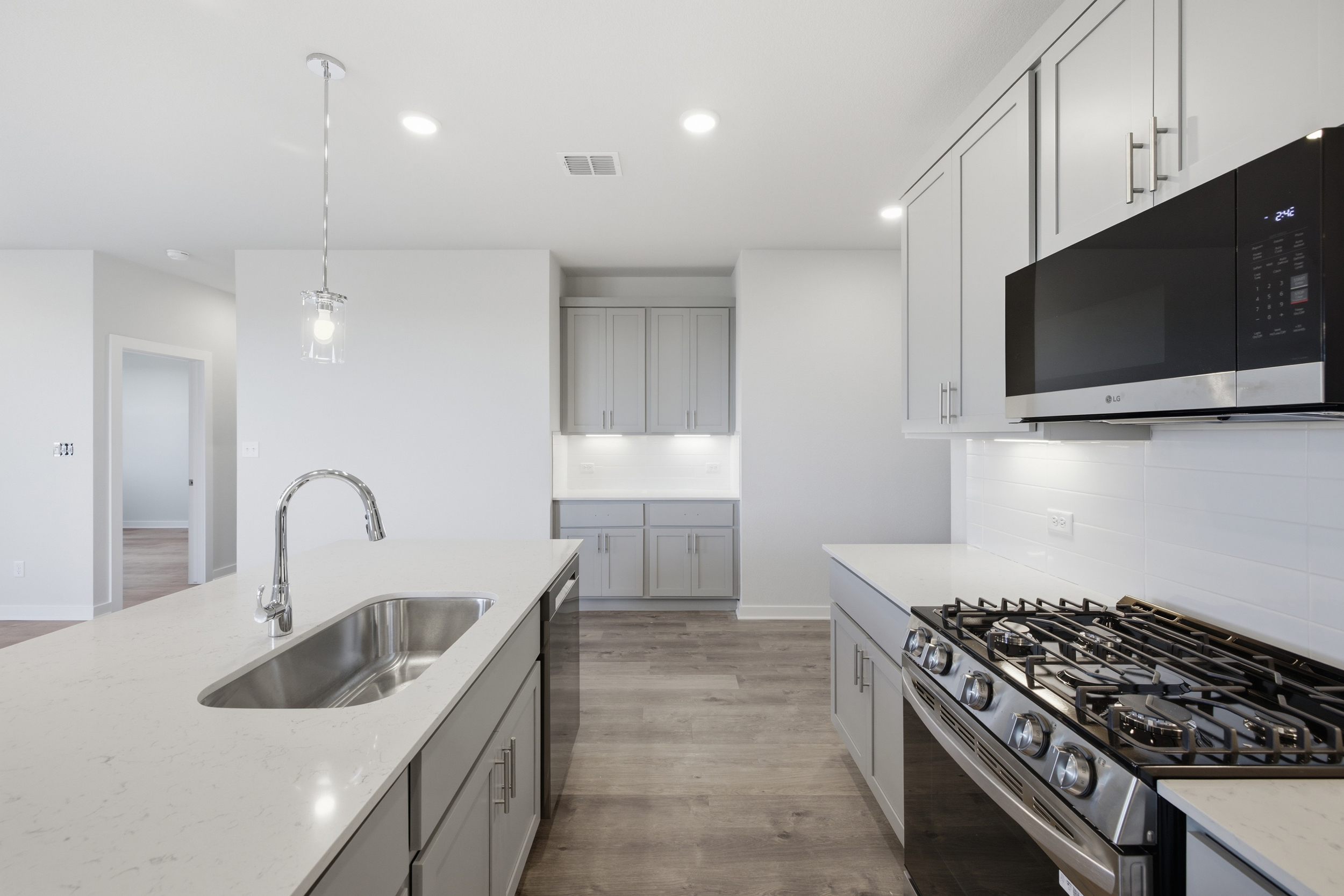 A kitchen with white cabinets.