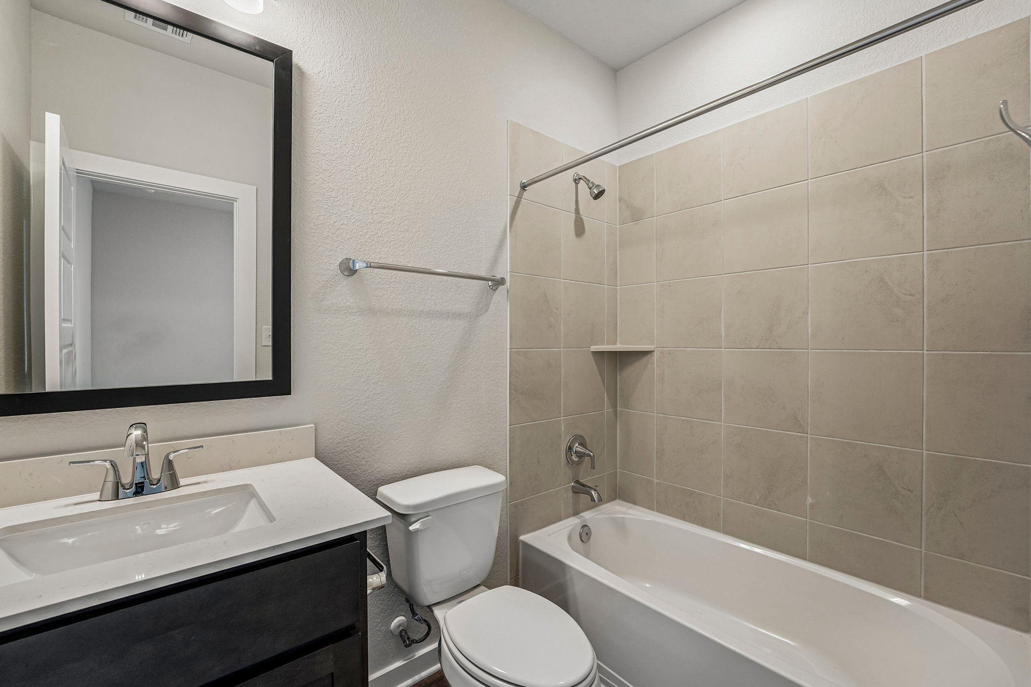 A bathroom with a tub toilet and sink.