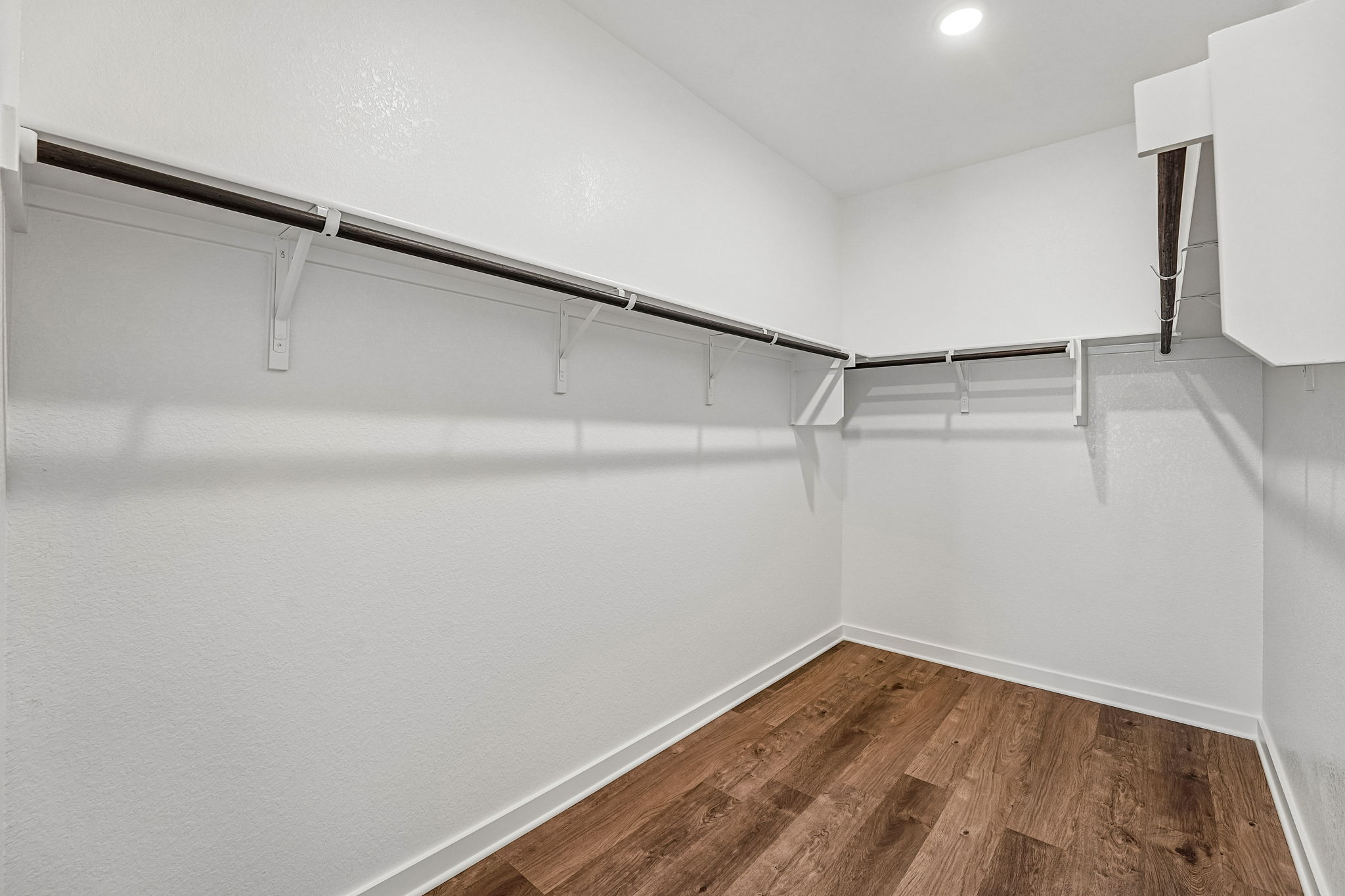 A white room with a wood floor.