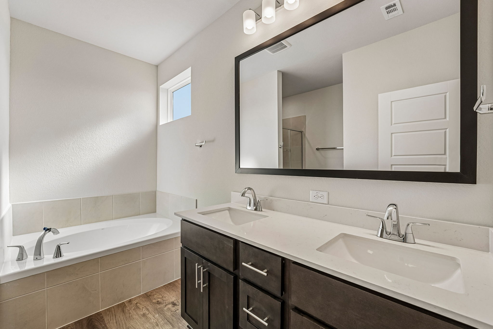 A bathroom with a large mirror.