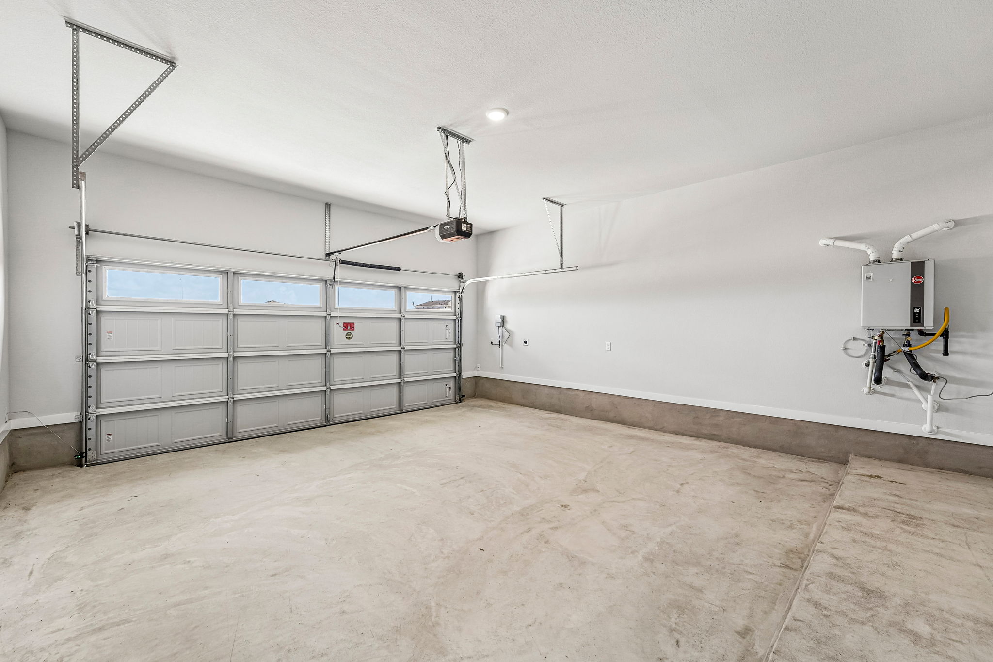 A room with a white wall and a metal gate.