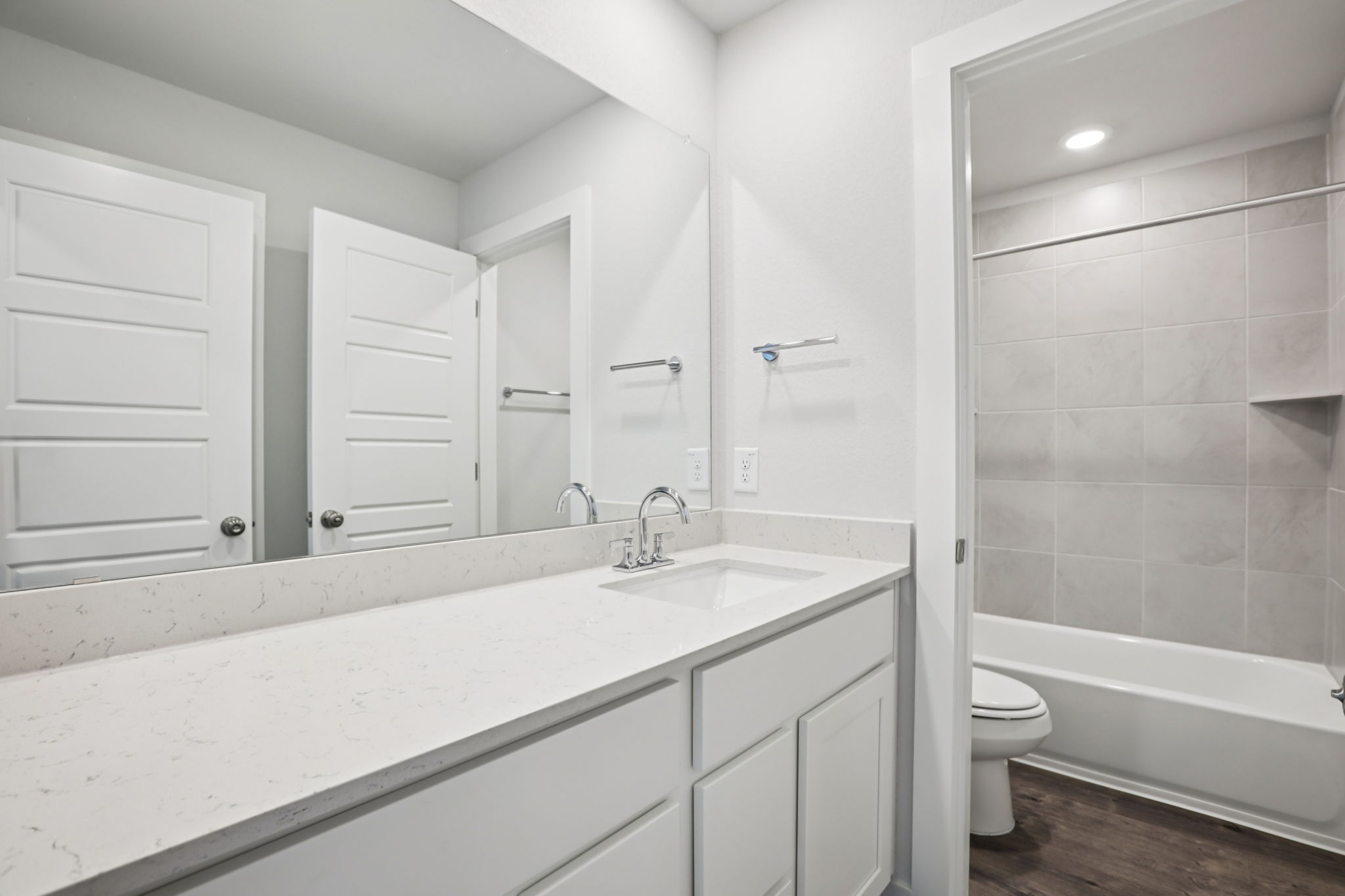 A bathroom with a tub sink and toilet.